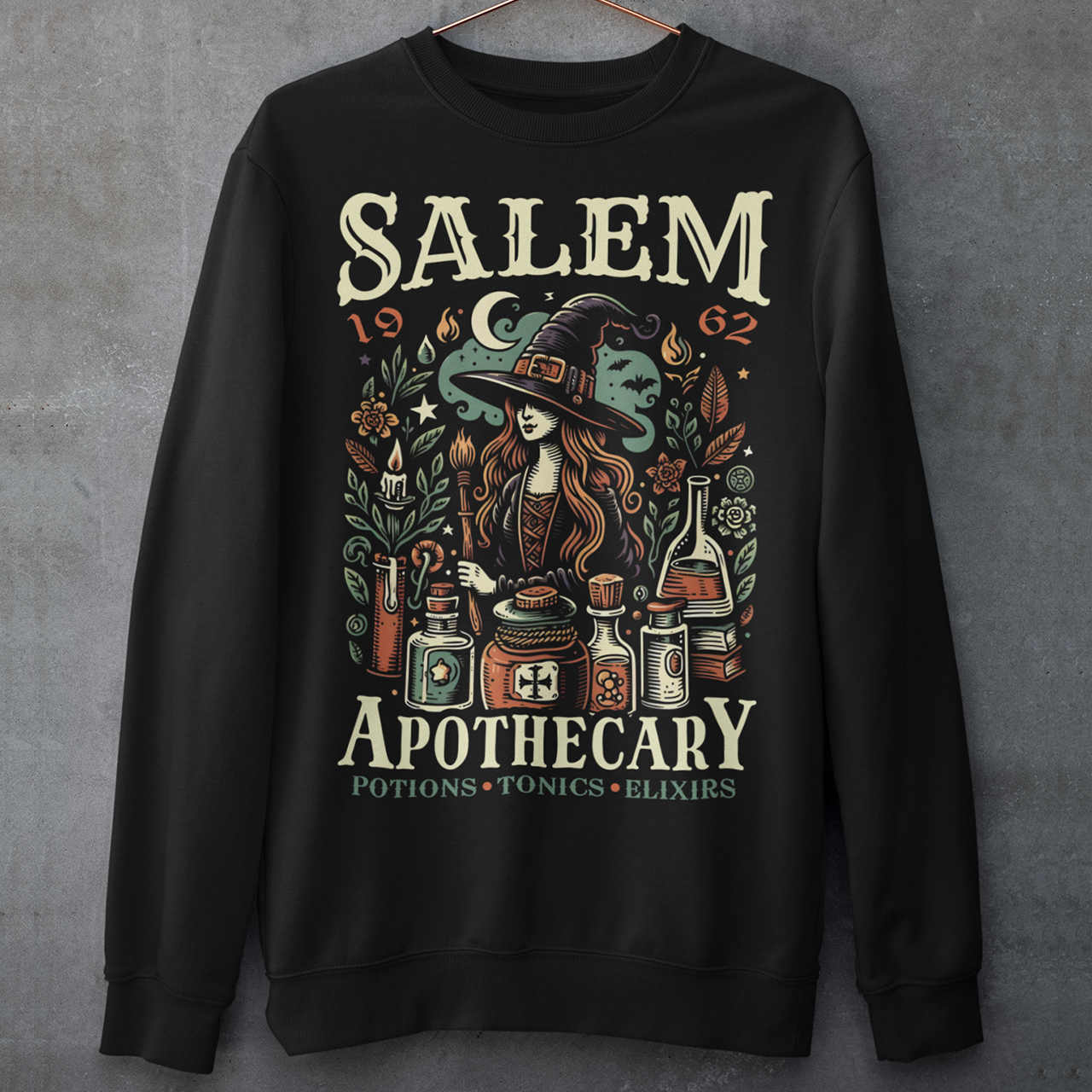 Step into the mystique of Salem with our "Salem Apothecary" Sweatshirt, a perfect blend of witchy charm and vintage flair. This design features a captivating witch, dressed in traditional attire, brewing potions with an array of mystical bottles and herbs. On the design the words "SALEM APOTHECARY" are prominently displayed, evoking the enchanting atmosphere of an old-world potion shop. This shirt is ideal for those who love the allure of witchcraft and the history of Salem.