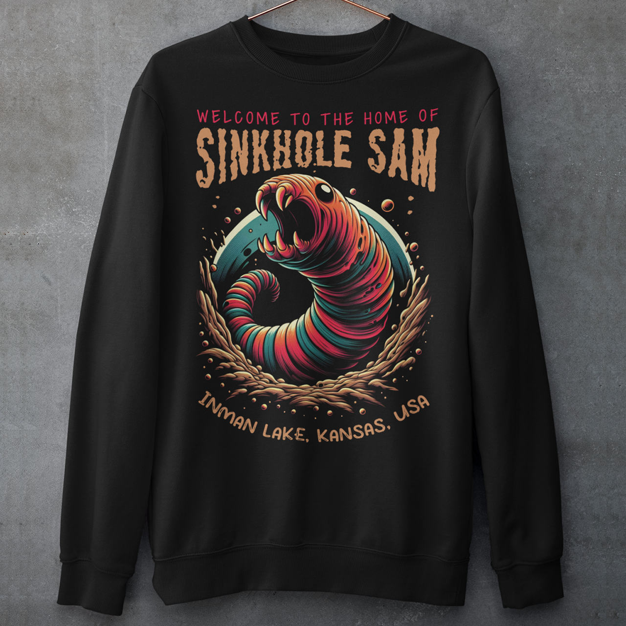 Unleash your inner cryptid enthusiast with our exclusive Sinkhole Sam Sweatshirt! This shirt features a bold, vibrant graphic of the legendary creature from Kansas folklore, brought to life in stunning detail. Sinkhole Sam, the elusive serpent-like beast rumored to inhabit the deep waters of Inman Lake, is depicted in a dramatic, eye-catching design that captures the mystery and excitement of this local legend.