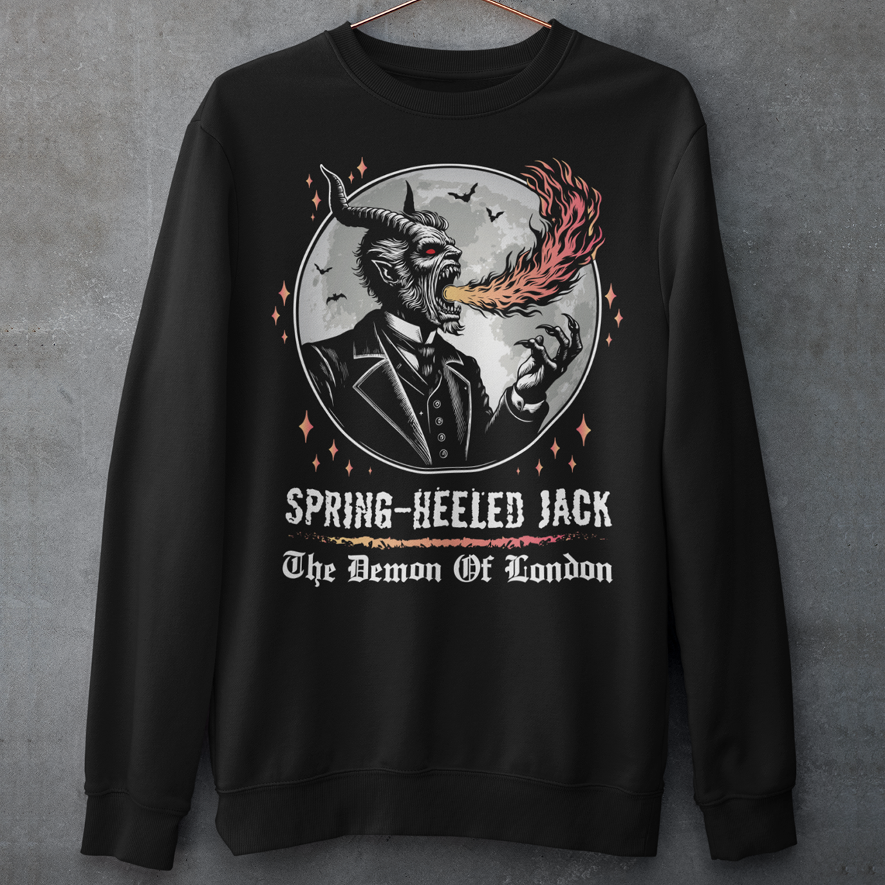 Introducing our electrifying Spring-heeled Jack sweatshirt, a striking fusion of folklore and urban legend! Against the backdrop of a hauntingly illuminated moon, Spring-heeled Jack leaps into action, exhaling flames with an otherworldly flair. This enigmatic figure, shrouded in mystery and mischief, has long captured the imagination of Londoners and beyond. With intricate detail and bold colors, our design brings to life the infamous character known as the "Demon of London.