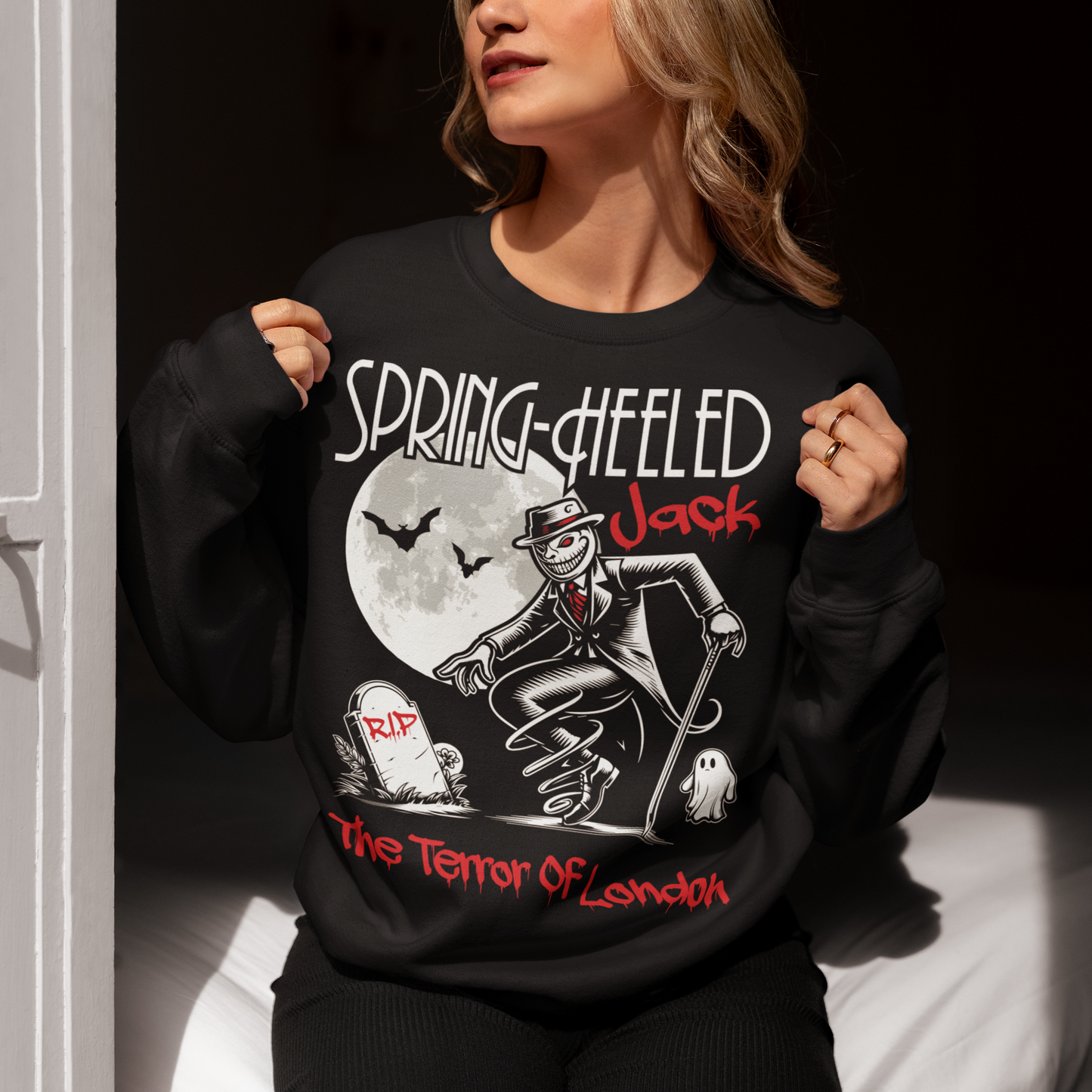 At the center of this striking sweatshirt design stands Spring-heeled Jack, the enigmatic figure of Victorian urban legend. Rendered in bold lines and vibrant colors, Spring-heeled Jack exudes an air of mystery and menace. His elongated figure seems to leap from the fabric, his eyes gleaming with an otherworldly intensity.