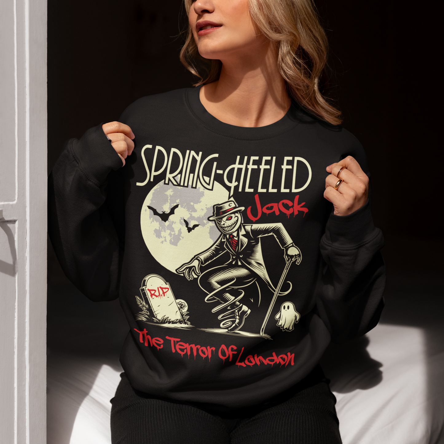 At the center of this striking sweatshirt design stands Spring-heeled Jack, the enigmatic figure of Victorian urban legend. Rendered in bold lines and vibrant colors, Spring-heeled Jack exudes an air of mystery and menace. His elongated figure seems to leap from the fabric, his eyes gleaming with an otherworldly intensity.