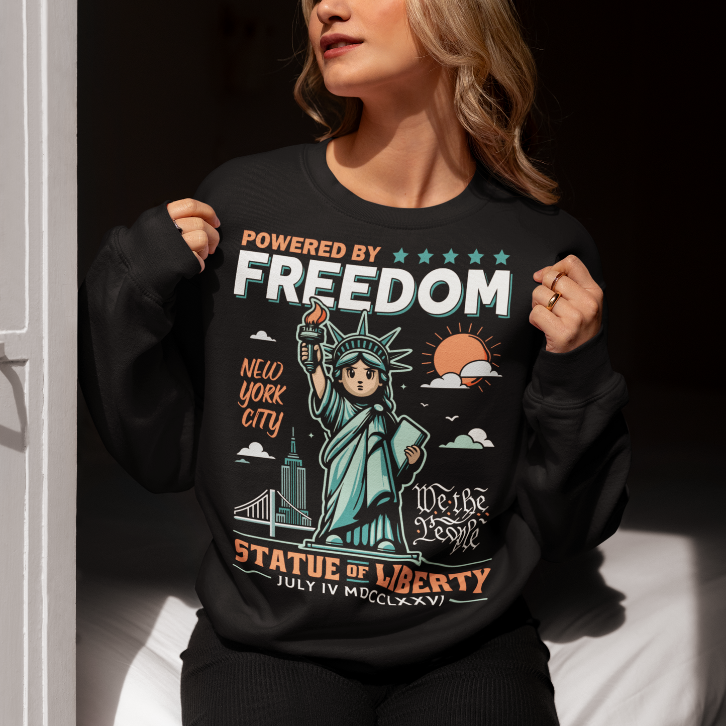 This sweatshirt features a bold cartoon rendition of the Statue of Liberty—full of attitude and charm—striking a heroic pose with a torch blazing high. Above her, the slogan "POWERED BY FREEDOM" pops in all-caps, making a loud and proud statement. This shirt is perfect for anyone who believes freedom isn't just a right—it's a superpower. Great for July 4th, rallies, or just everyday rebel energy.