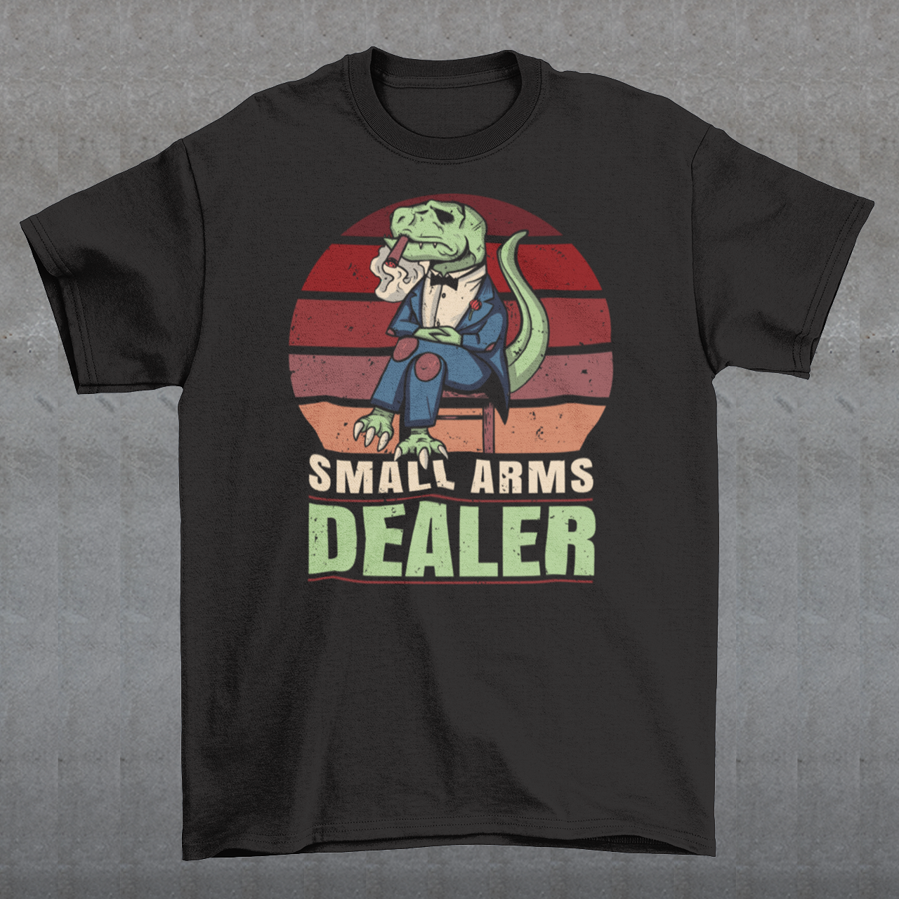 Introducing our one-of-a-kind "Small Arms Dealer" T-shirt, a roaring blend of prehistoric power and modern-day swagger! This tee showcases a whimsical and unforgettable design that's sure to turn heads and spark conversations.
In the heart of the Cretaceous era, meet our mafia T-Rex, dressed to impress in a sleek, pinstriped suit. With a cigar perched confidently between his tiny T-Rex teeth, he exudes an air of authority and a touch of humor.