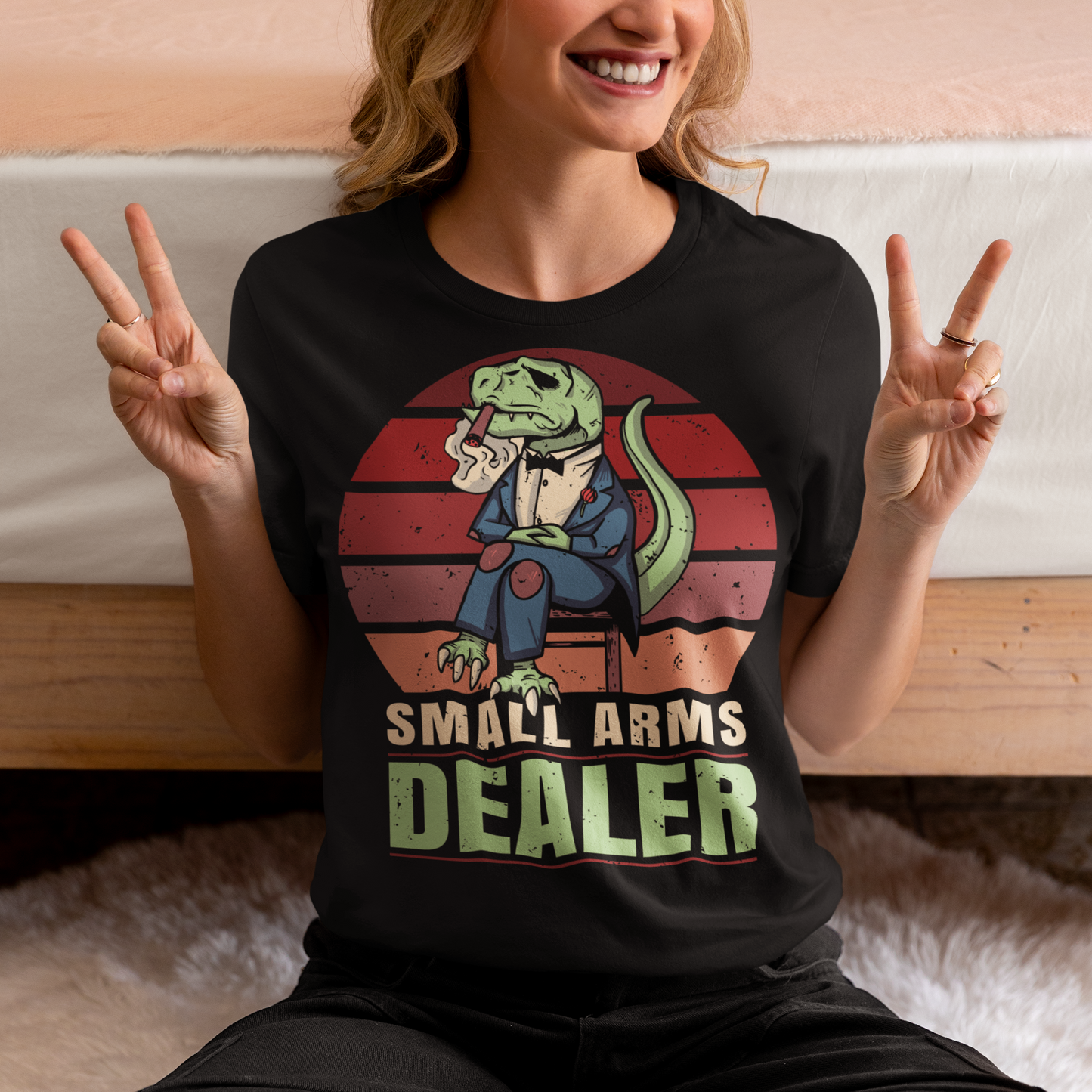 Introducing our one-of-a-kind "Small Arms Dealer" T-shirt, a roaring blend of prehistoric power and modern-day swagger! This tee showcases a whimsical and unforgettable design that's sure to turn heads and spark conversations.
In the heart of the Cretaceous era, meet our mafia T-Rex, dressed to impress in a sleek, pinstriped suit. With a cigar perched confidently between his tiny T-Rex teeth, he exudes an air of authority and a touch of humor.