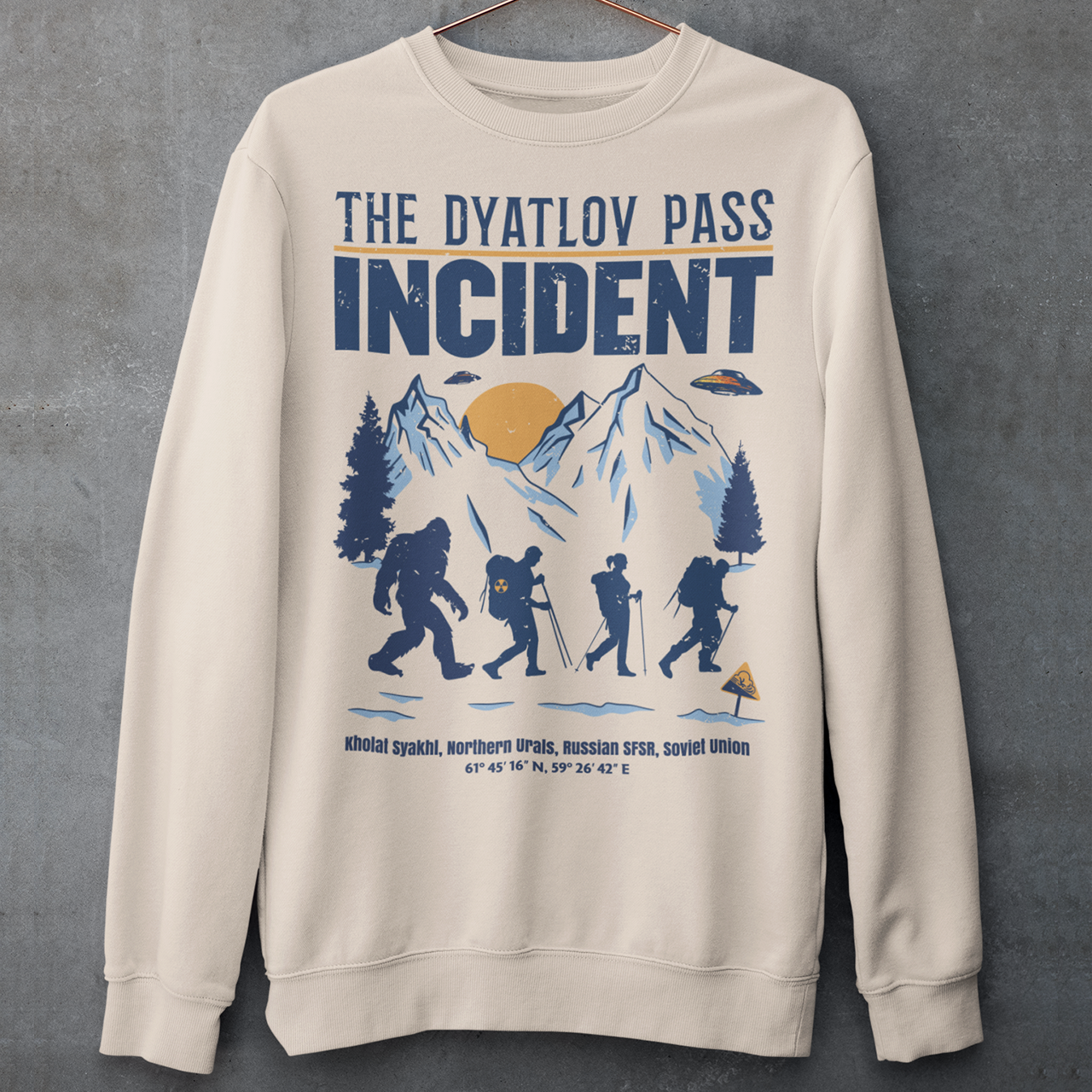 Embark on an enigmatic journey with our captivating 'Dyatlov Pass Incident' t-shirt! This unique design captures the mystique of snowy mountain ranges, featuring a group of adventurous hikers traversing the wintry landscape. Amidst the serene snow-covered peaks, mysterious UFOs hover above, adding an element of otherworldly intrigue to the scene. At the tail end of the group stands the elusive figure of Bigfoot, shrouded in the enigma of the untamed wilderness.