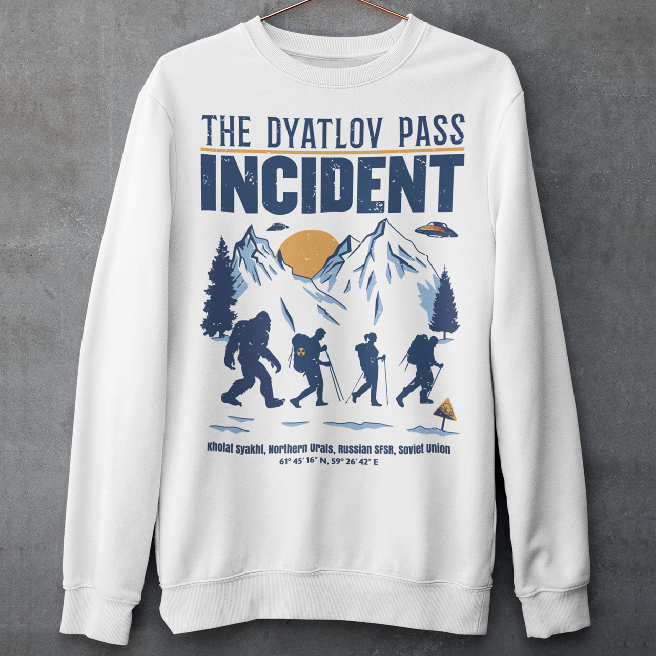 Embark on an enigmatic journey with our captivating 'Dyatlov Pass Incident' t-shirt! This unique design captures the mystique of snowy mountain ranges, featuring a group of adventurous hikers traversing the wintry landscape. Amidst the serene snow-covered peaks, mysterious UFOs hover above, adding an element of otherworldly intrigue to the scene. At the tail end of the group stands the elusive figure of Bigfoot, shrouded in the enigma of the untamed wilderness.