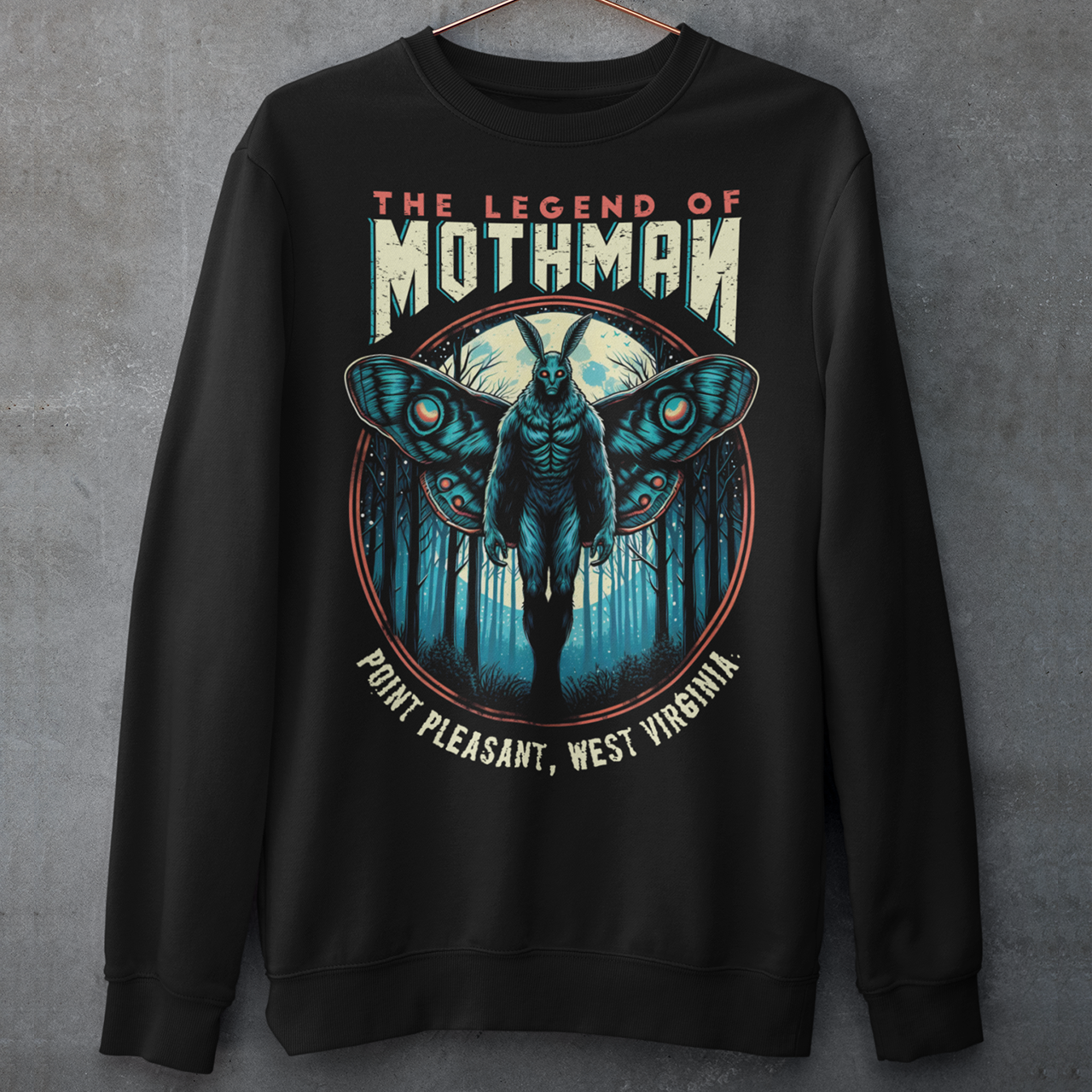 This captivating sweatshirt features a striking illustration of Mothman, the legendary cryptid, standing mysteriously in a dense, shadowy forest. The eerie scene captures the essence of folklore, with Mothman's glowing red eyes piercing through the darkness, creating an atmosphere of both intrigue and suspense. Above the enigmatic figure, bold text reads "THE LEGEND OF MOTHMAN," adding to the mystique and allure of this mythical creature.