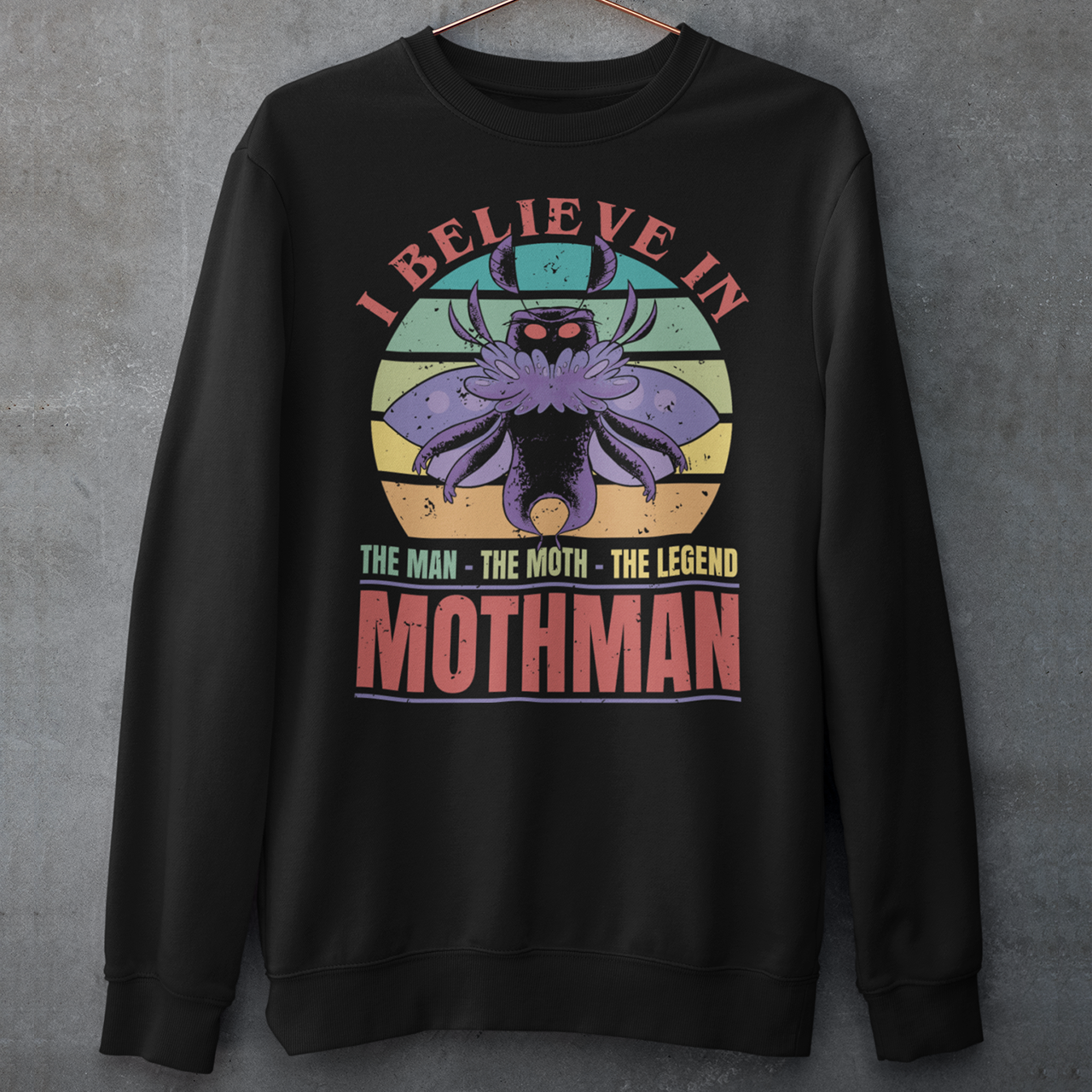 Introducing our legendary Mothman sweatshirt, a must-have for believers and enthusiasts alike! Embrace the enigmatic allure of the Mothman phenomenon with this captivating design featuring the iconic cryptid against a retro sun background.