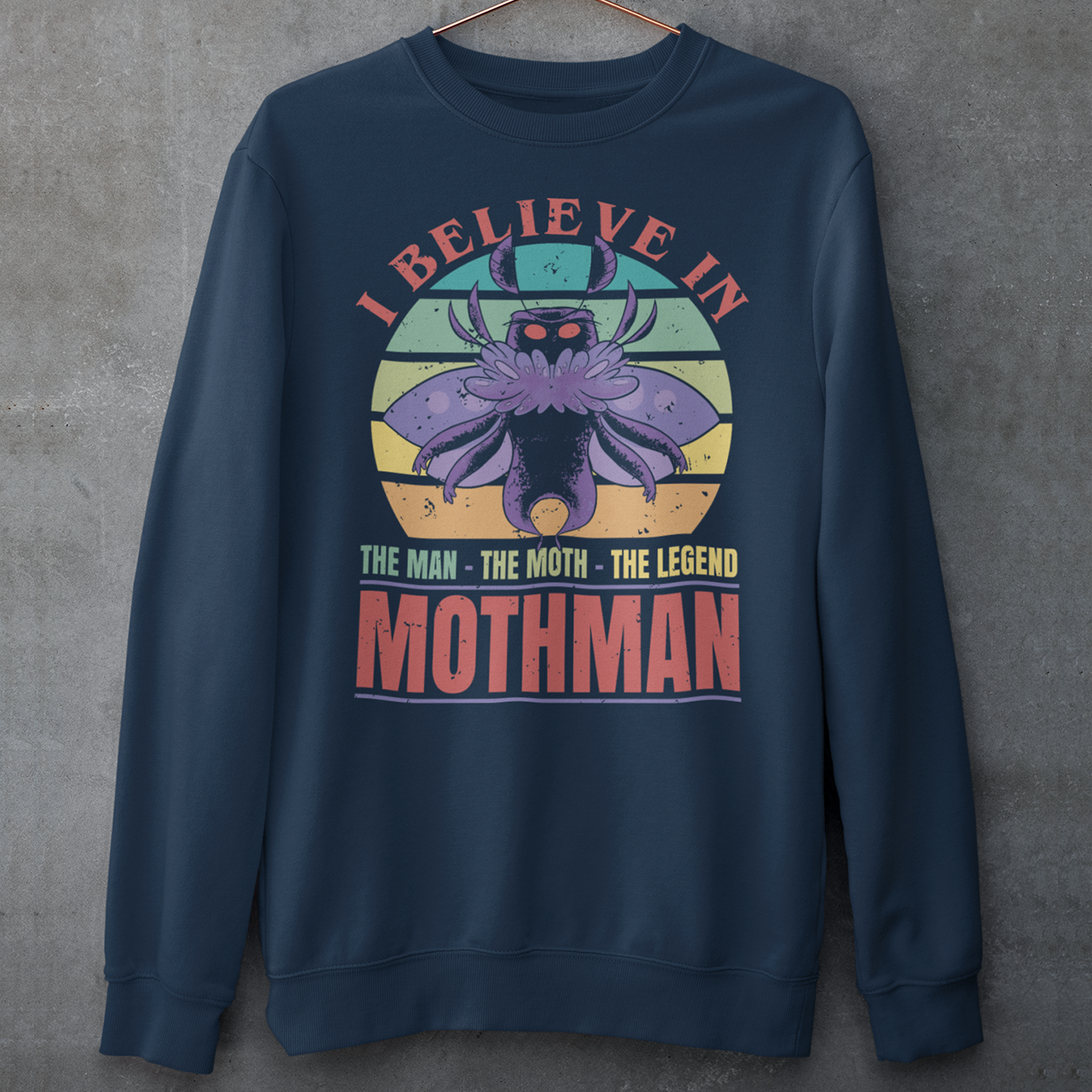 Introducing our legendary Mothman sweatshirt, a must-have for believers and enthusiasts alike! Embrace the enigmatic allure of the Mothman phenomenon with this captivating design featuring the iconic cryptid against a retro sun background.