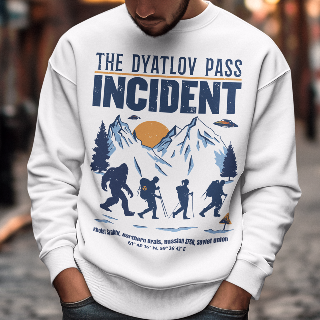 Embark on an enigmatic journey with our captivating 'Dyatlov Pass Incident' t-shirt! This unique design captures the mystique of snowy mountain ranges, featuring a group of adventurous hikers traversing the wintry landscape. Amidst the serene snow-covered peaks, mysterious UFOs hover above, adding an element of otherworldly intrigue to the scene. At the tail end of the group stands the elusive figure of Bigfoot, shrouded in the enigma of the untamed wilderness.