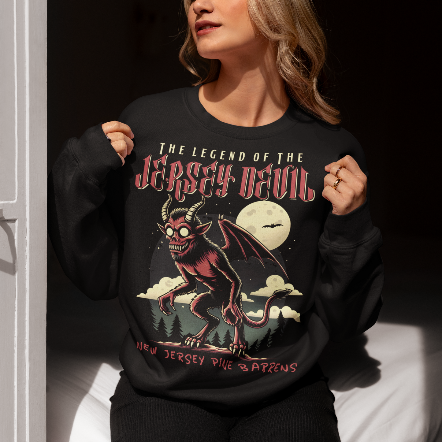 "Embrace the mystery with our Jersey Devil sweatshirt! Featuring a striking depiction of the legendary creature , this shirt captures the intrigue and folklore of the New Jersey Pine Barrens. Above, bold letters declare 'THE LEGEND OF THE JERSEY DEVIL,' invoking tales of its enigmatic presence. Below, 'THE NEW JERSEY PINE BARRENS' grounds the design in the eerie beauty of its natural habitat. Wear it to ignite conversations and inspire curiosity about this enduring myth."