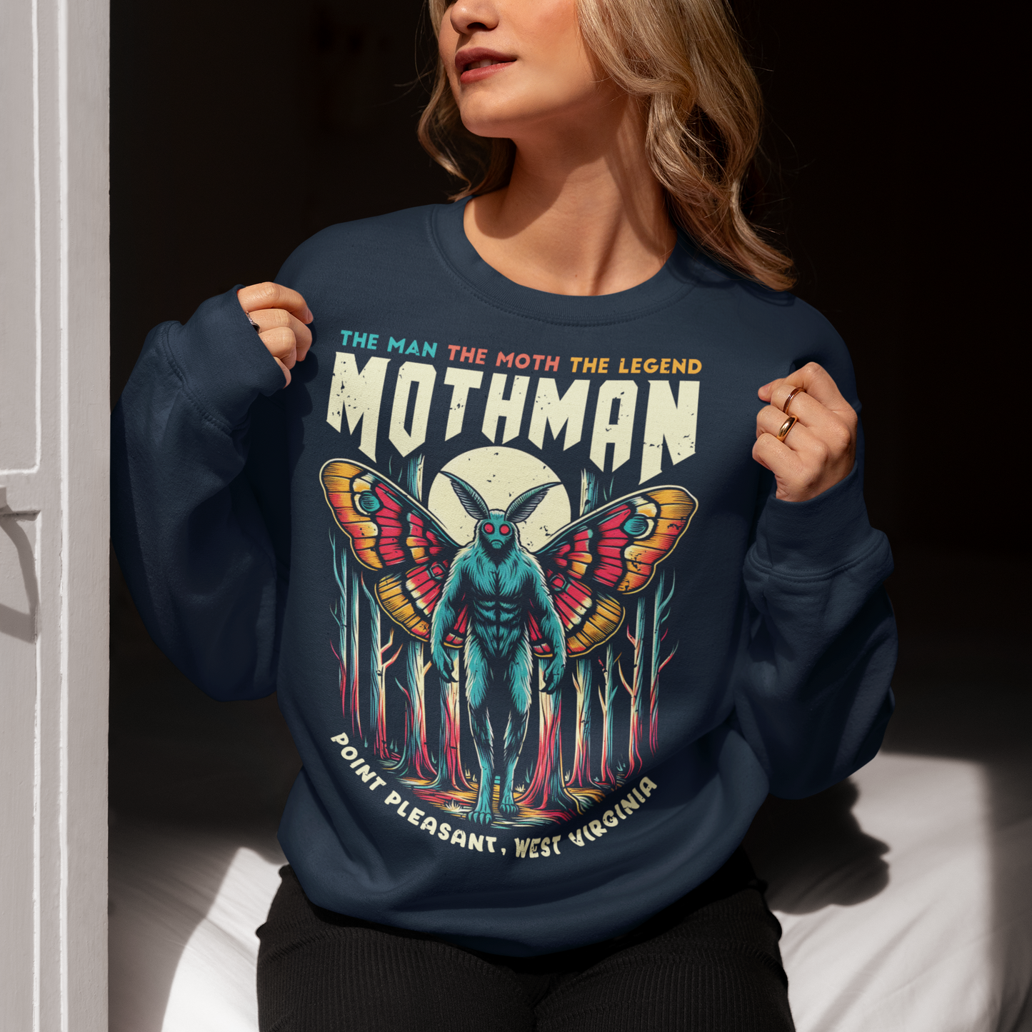 Navy sweatshirt of Mothman in a forest with text above THE MAN THE MOTH THE LEGEND MOTHMAN.