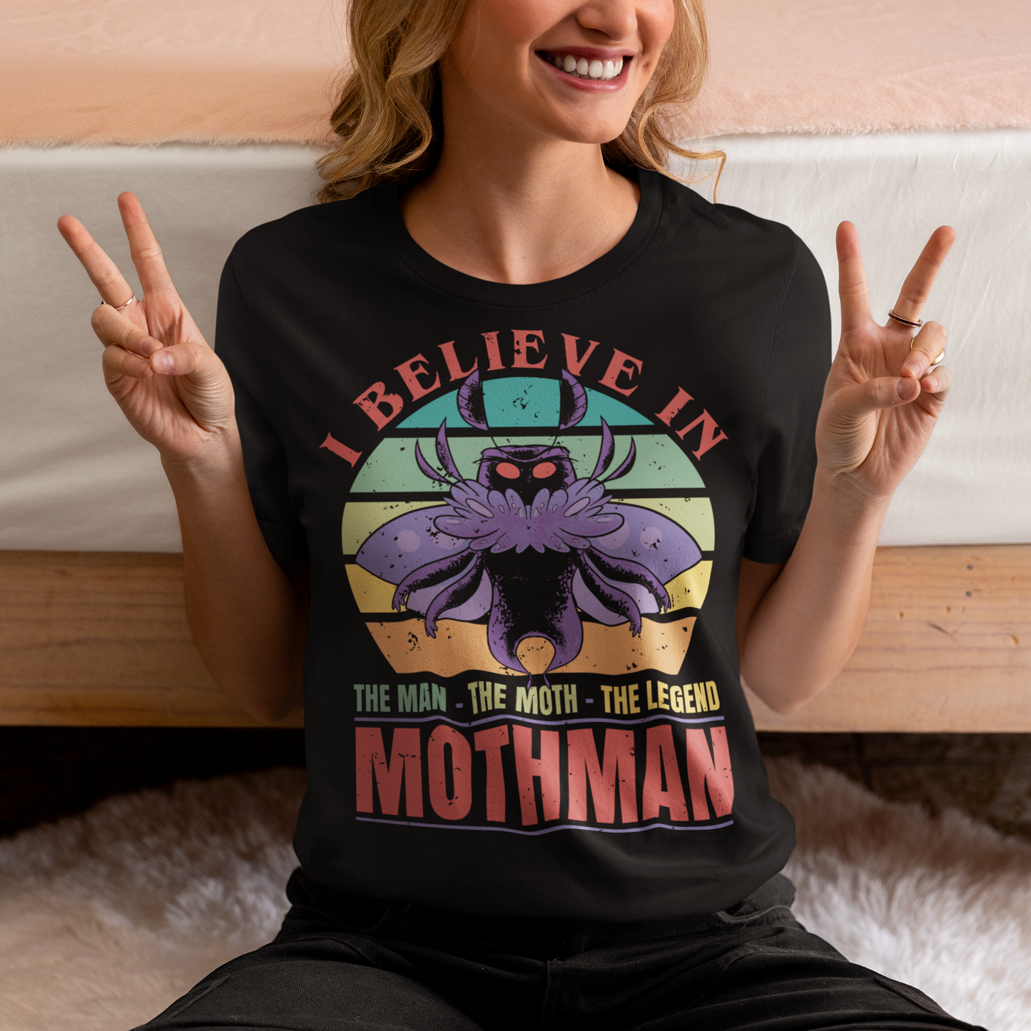 Introducing our legendary Mothman t-shirt, a must-have for believers and enthusiasts alike! Embrace the enigmatic allure of the Mothman phenomenon with this captivating design featuring the iconic cryptid against a retro sun background.