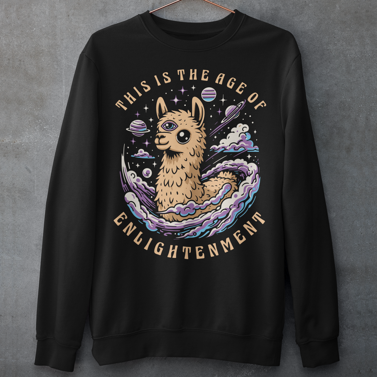 Embrace cosmic wisdom with our captivating Llama sweatshirt! Picture this: amidst the vast expanse of space, a serene Llama gazes into the universe, its third eye gleaming with enlightenment. With swirling galaxies as its backdrop, this design captures the essence of transcendence and insight. Around the celestial spectacle, bold text declares, 'THIS IS THE AGE OF ENLIGHTENMENT,' heralding a new era of awareness and understanding.