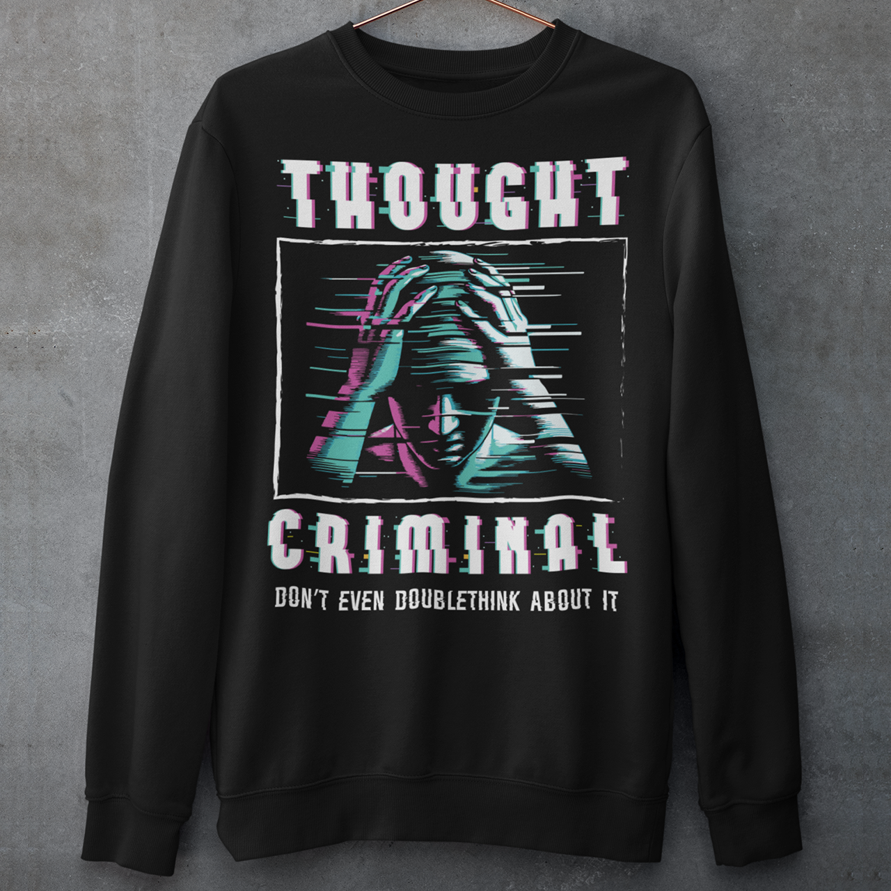 This bold and edgy Sweatshirt features the phrase "THOUGHT CRIMINAL" in a glitched, distorted font, giving it a rebellious, cyberpunk-inspired aesthetic. The design evokes themes of censorship, free thought, and dystopian resistance, making it perfect for those who challenge the status quo. Whether you're a fan of cyberpunk, retro-futurism, or just love thought-provoking designs, this tee is sure to turn heads.