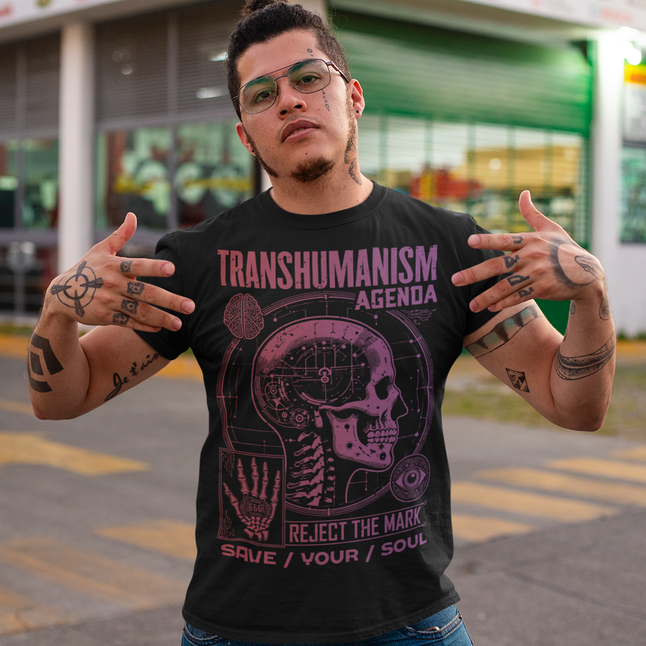 Graphic t-shirt featuring a futuristic 'Transhumanism Agenda' theme, depicting a humanoid figure with robotic enhancements and a glowing digital eye. The figure bears the 'mark of the beast'—a barcode or microchip symbol—on its forehead. Circuit patterns and neon blue lines radiate across a dark, high-tech background, emphasizing a dystopian fusion of man and machine. The design suggests a cautionary message about technology and identity.