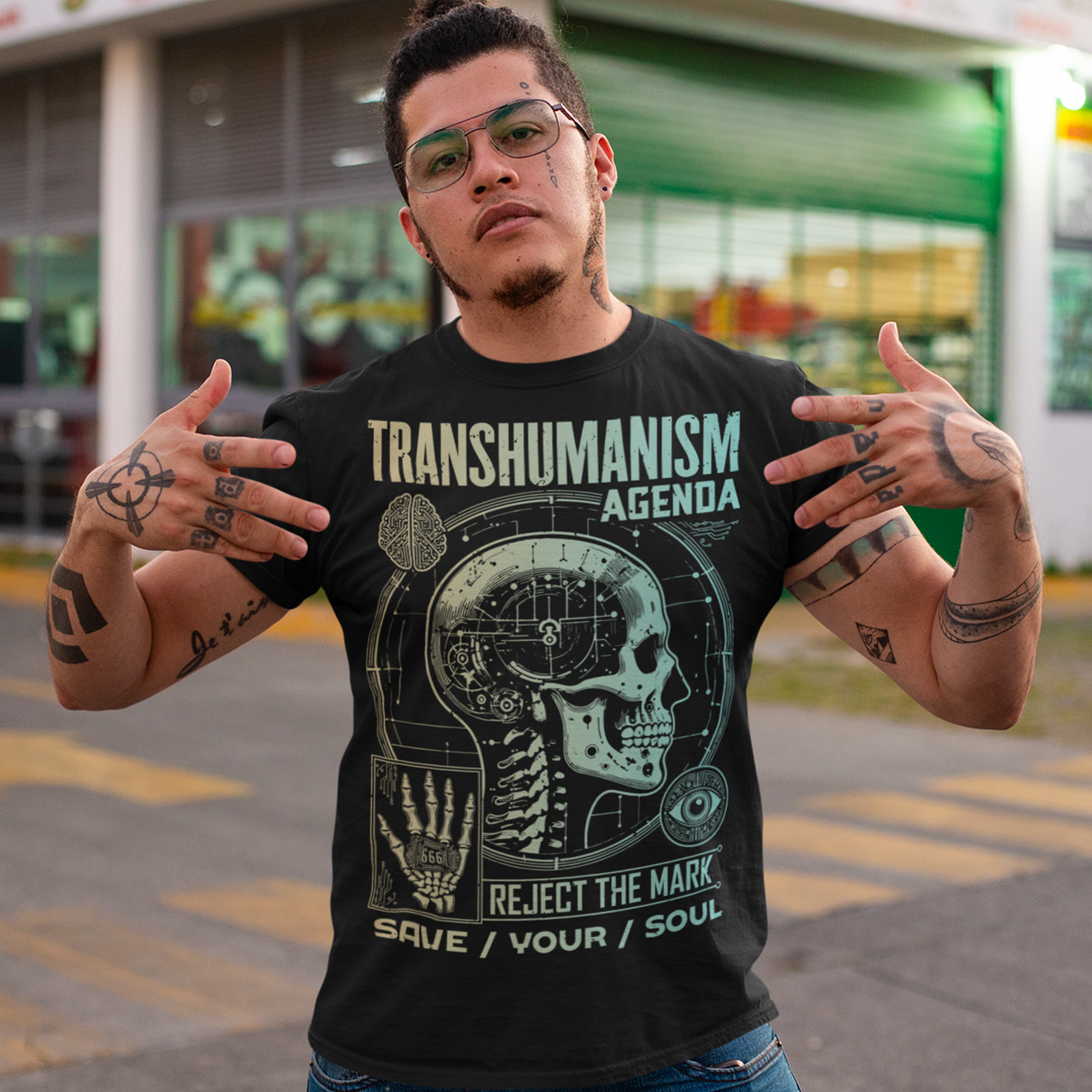 Graphic t-shirt featuring a futuristic 'Transhumanism Agenda' theme, depicting a humanoid figure with robotic enhancements and a glowing digital eye. The figure bears the 'mark of the beast'—a barcode or microchip symbol—on its forehead. Circuit patterns and neon blue lines radiate across a dark, high-tech background, emphasizing a dystopian fusion of man and machine. The design suggests a cautionary message about technology and identity.