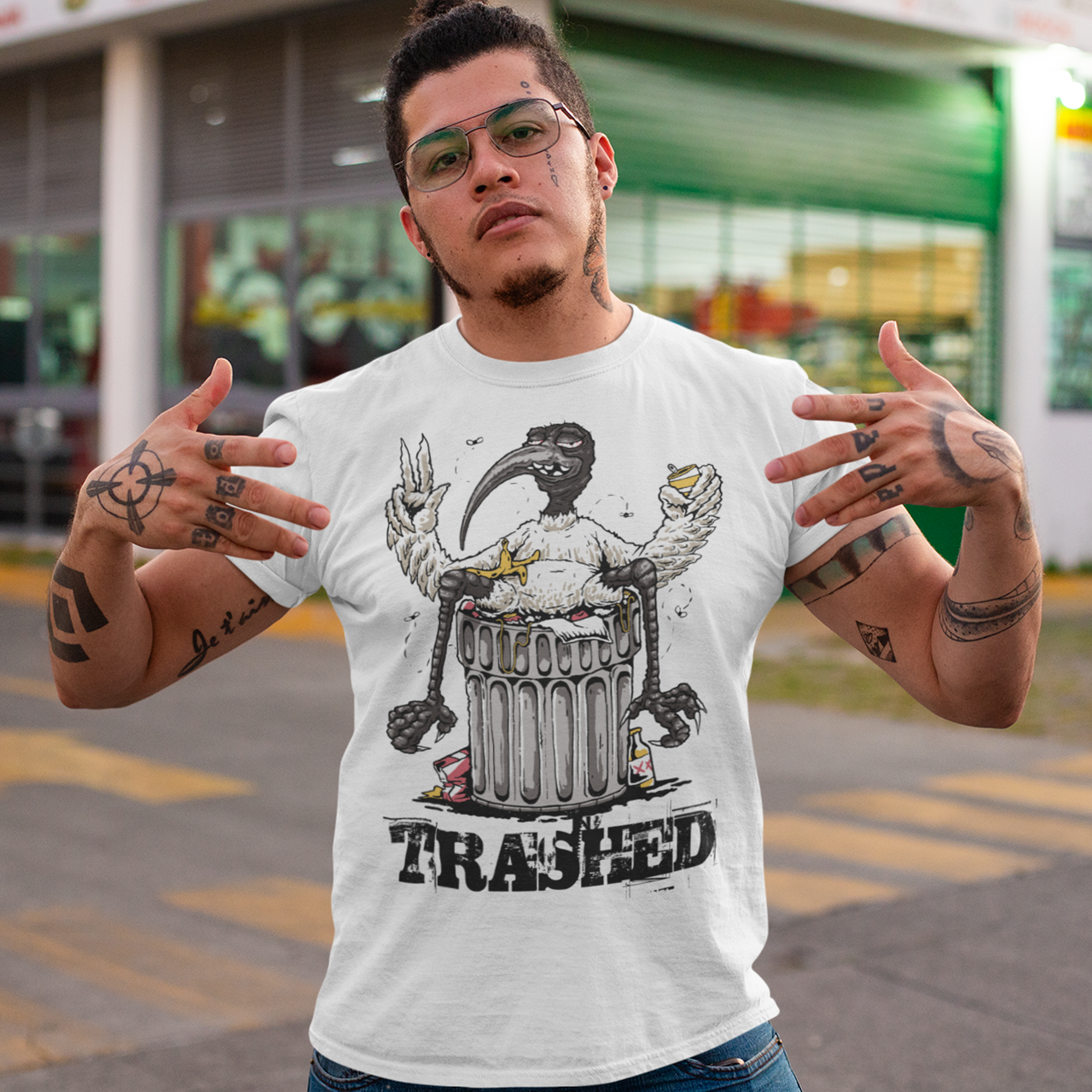Introducing our latest t-shirt design, featuring a bird lying on a trash can with the text "TRASHED" emblazoned on bottom. This eye-catching design perfectly captures the nonchalant attitude of our feathered friend as it lounges atop a heap of discarded items. Whether you're looking to make a bold statement or simply appreciate the humor in the design, this "TRASHED" t-shirt is sure to turn heads and spark conversations. So why wait? Add it to your wardrobe today and let your style take flight!