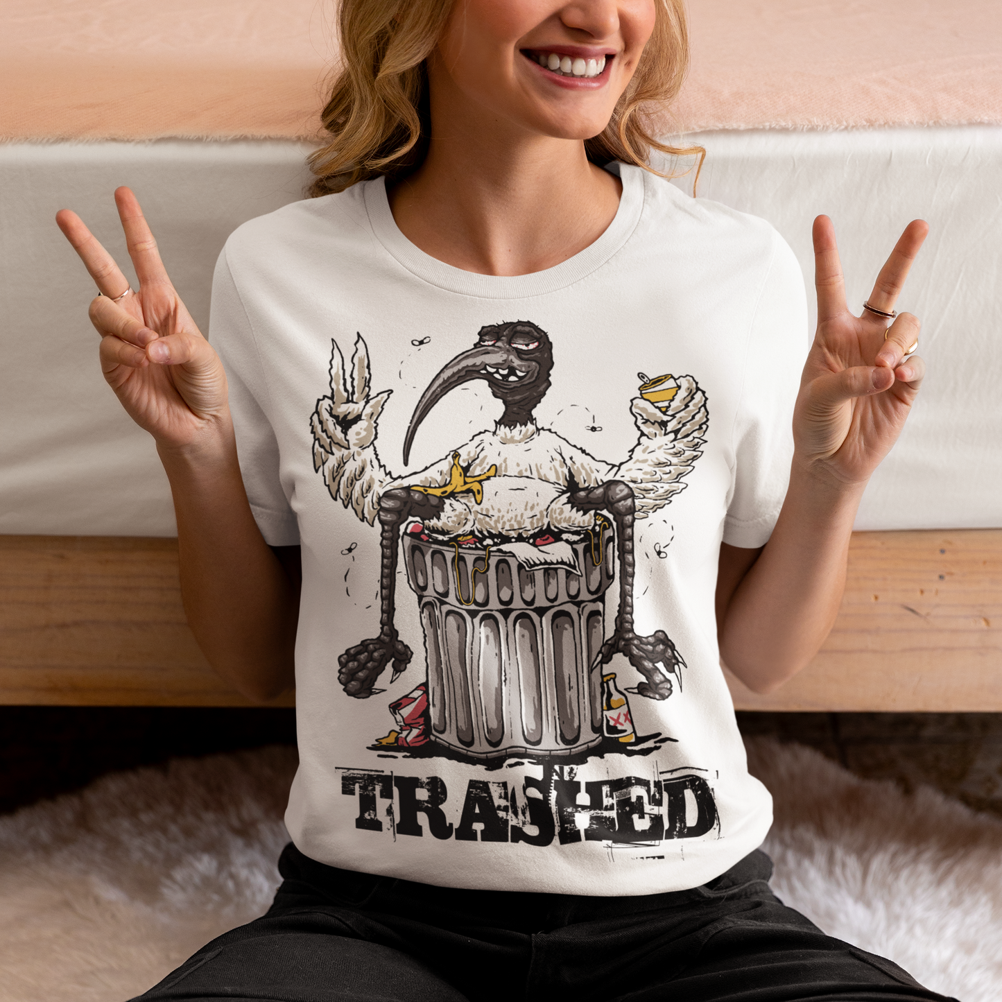 Introducing our latest t-shirt design, featuring a bird lying on a trash can with the text "TRASHED" emblazoned on bottom. This eye-catching design perfectly captures the nonchalant attitude of our feathered friend as it lounges atop a heap of discarded items. Whether you're looking to make a bold statement or simply appreciate the humor in the design, this "TRASHED" t-shirt is sure to turn heads and spark conversations. So why wait? Add it to your wardrobe today and let your style take flight!