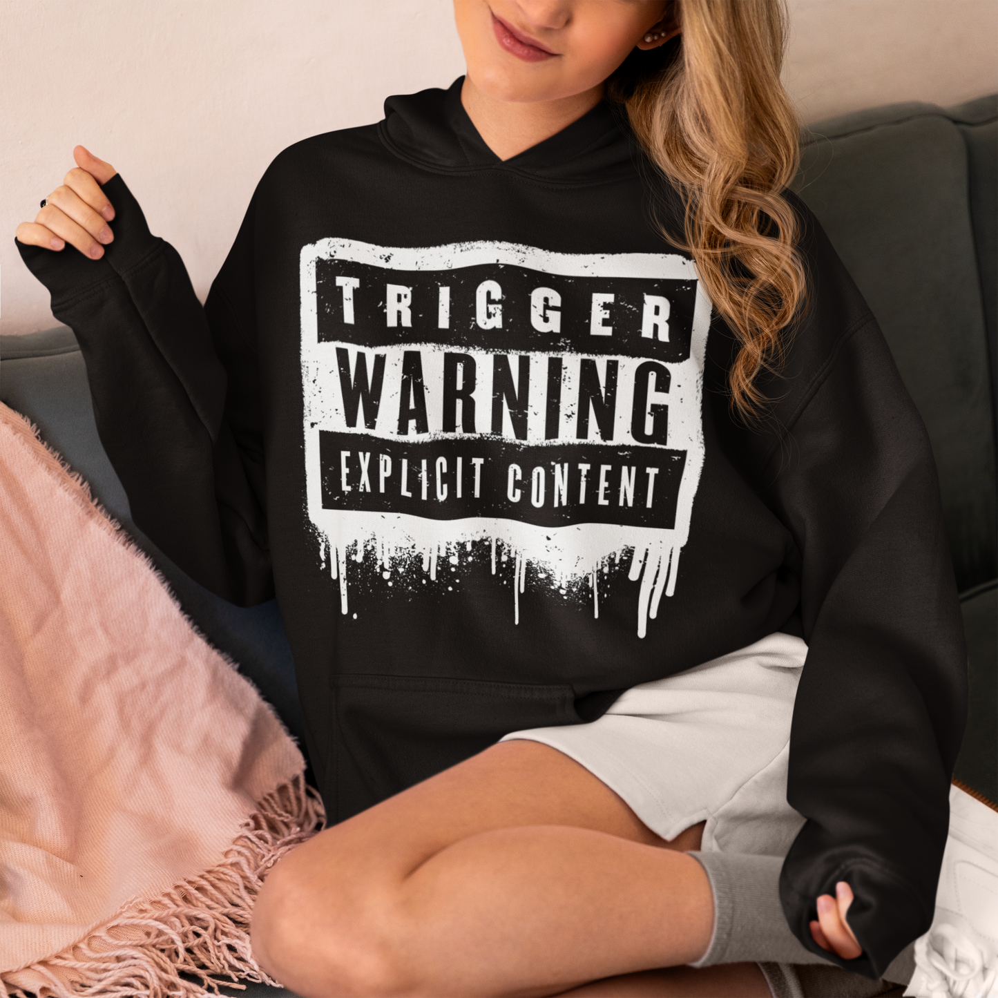 This hoodie features a bold paint design with the words "Trigger Warning" and "Explicit Content". The message is clear and direct, warning others that the content may be disturbing or offensive.
