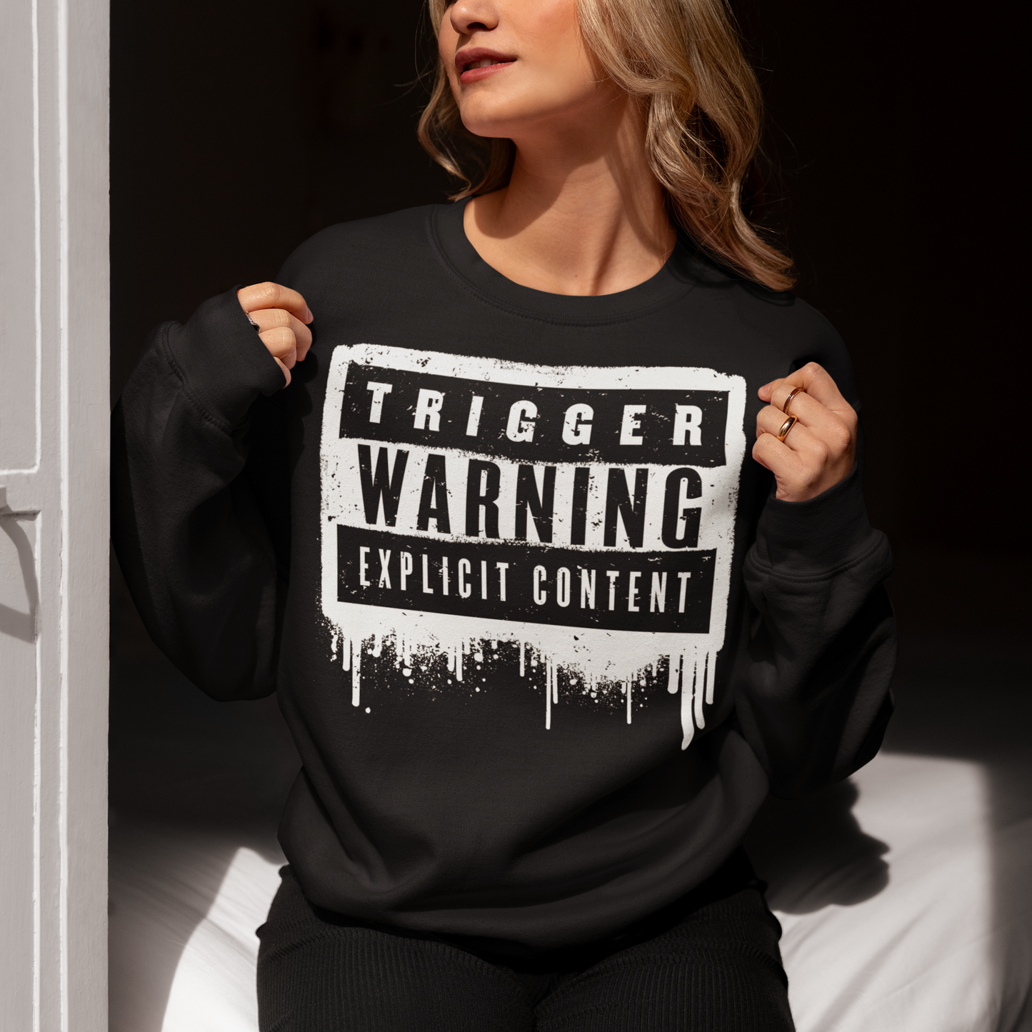This sweatshirt features a bold paint design with the words "Trigger Warning" and "Explicit Content". The message is clear and direct, warning others that the content may be disturbing or offensive.