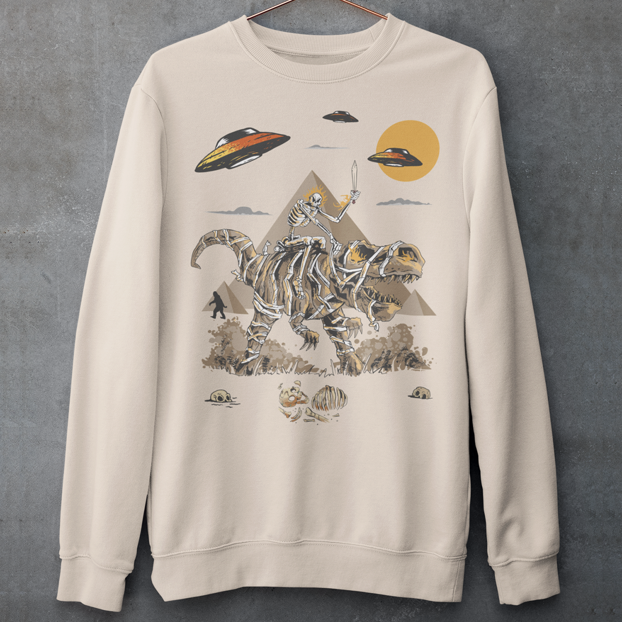 Get ready to embark on an epic adventure with our mind-blowing sweatshirt design! Picture this: a skeleton riding a T-Rex through the ancient wonders of Egypt, with UFOs hovering in the sky and Bigfoot mysteriously lurking in the background. It's a jaw-dropping fusion of history, mythology, and the unknown, all beautifully captured in one captivating design.