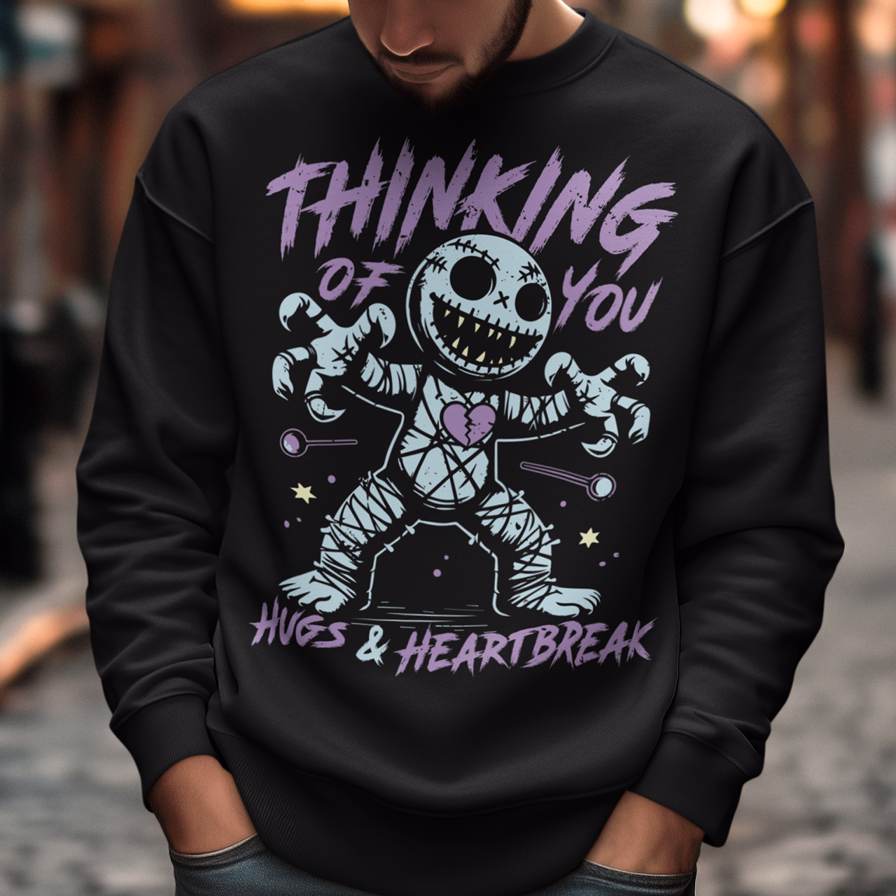 Dark humor meets twisted sweetness with this bold sweatshirt. Featuring a stitched-up voodoo doll at the center, the design captures that perfect mix of love and pain. Above the doll, the phrase “THINKING OF YOU” adds a playful sting, while below, “HUGS & HEARTBREAK” ties it all together with equal parts irony and affection. Perfect for anyone who loves edgy, alternative fashion—or just wants to send a cheeky message without saying a word.