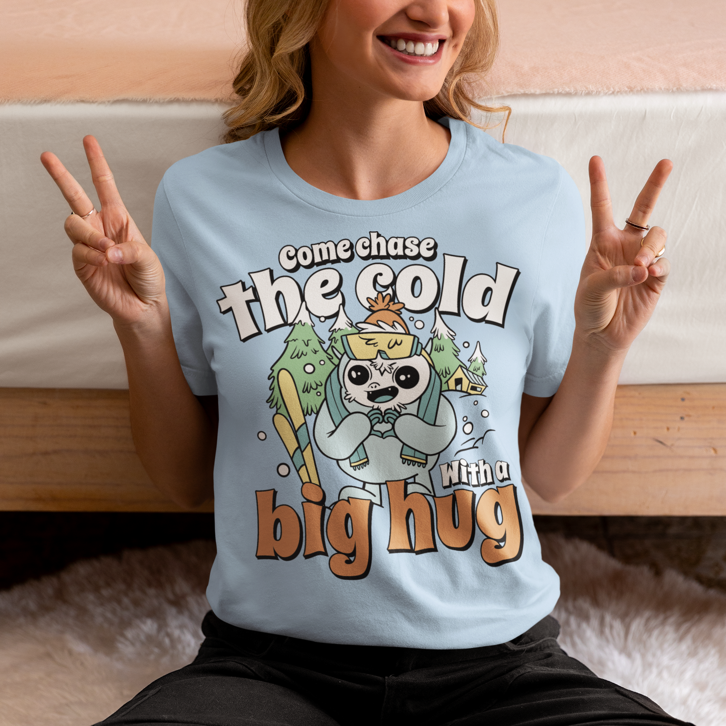 Hit the slopes in style with this playful Yeti Skiing t-shirt! Featuring a whimsical illustration of a friendly yeti standing in the snow, this design pairs perfectly with the cozy, heartwarming message: "Come chase the cold with a big hug." Whether you're a winter sports enthusiast or just love mythical creatures with a soft side, this tee wraps comfort, humor, and chill vibes into one awesome package.