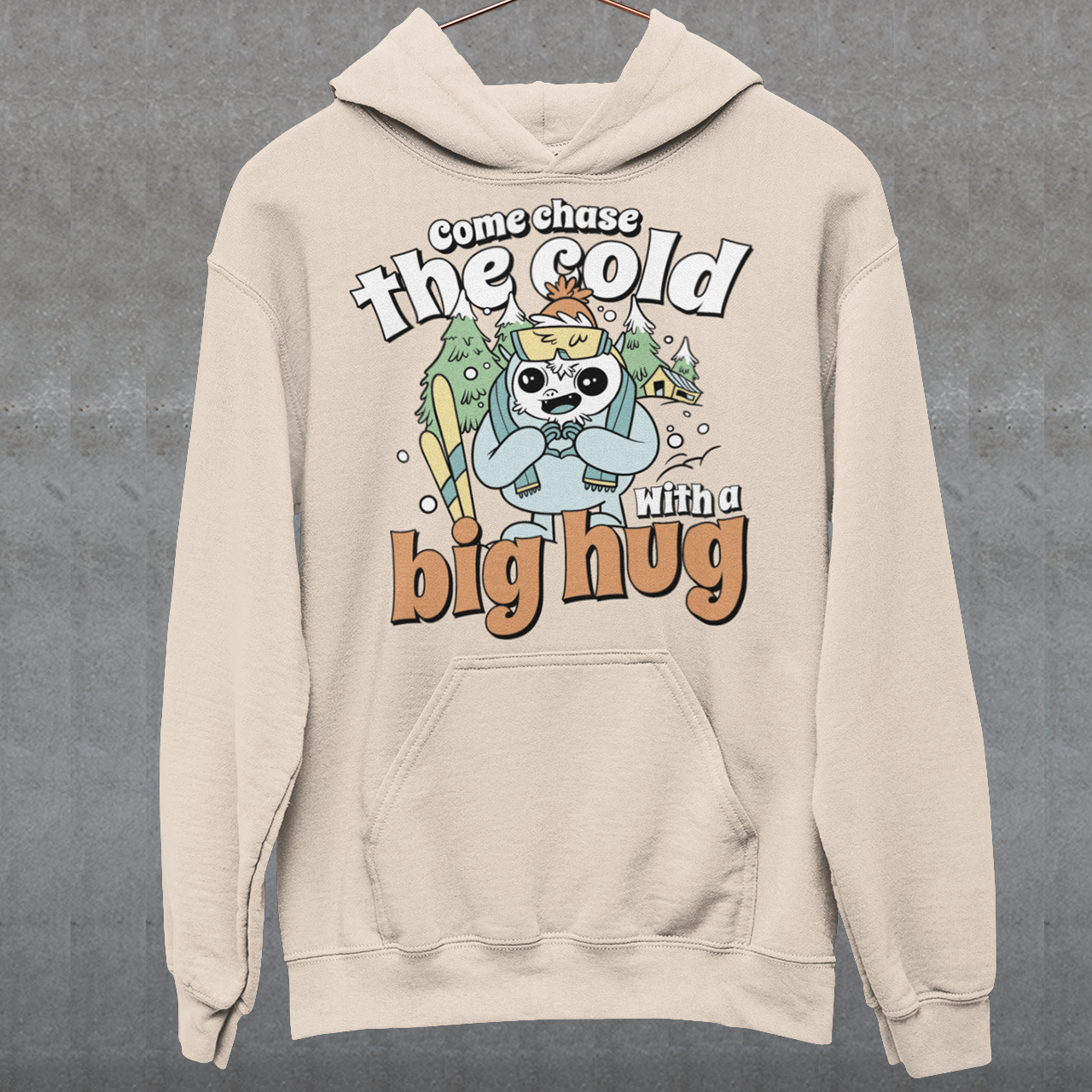 Hit the slopes in style with this playful Yeti Skiing hoodie! Featuring a whimsical illustration of a friendly yeti standing in the snow, this design pairs perfectly with the cozy, heartwarming message: "Come chase the cold with a big hug." Whether you're a winter sports enthusiast or just love mythical creatures with a soft side, this hoodie wraps comfort, humor, and chill vibes into one awesome package.
