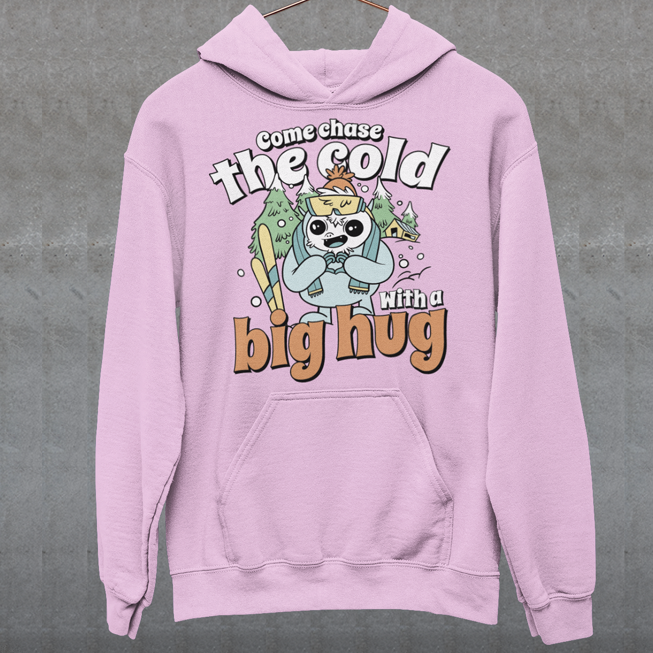 Hit the slopes in style with this playful Yeti Skiing hoodie! Featuring a whimsical illustration of a friendly yeti standing in the snow, this design pairs perfectly with the cozy, heartwarming message: "Come chase the cold with a big hug." Whether you're a winter sports enthusiast or just love mythical creatures with a soft side, this hoodie wraps comfort, humor, and chill vibes into one awesome package.