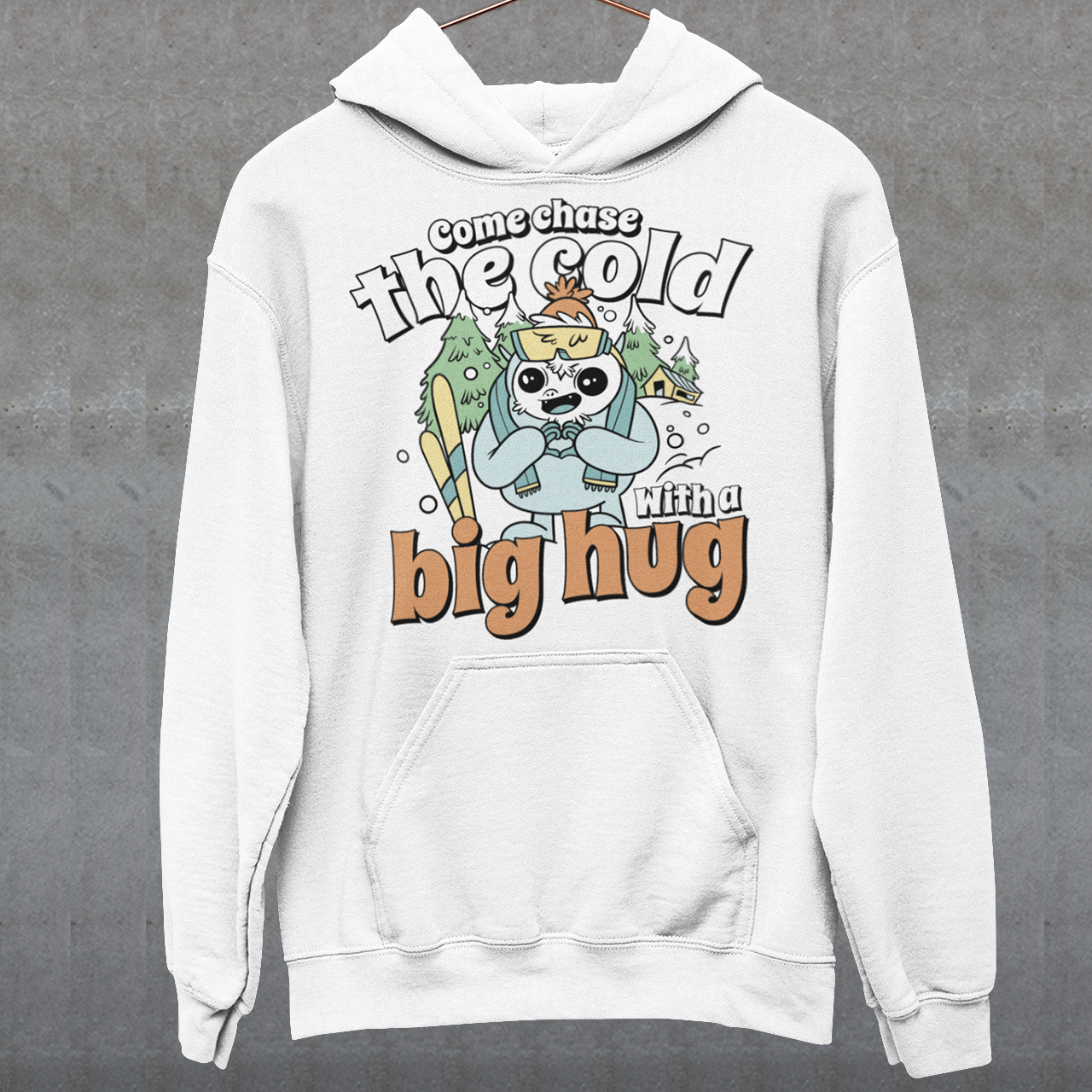 Hit the slopes in style with this playful Yeti Skiing hoodie! Featuring a whimsical illustration of a friendly yeti standing in the snow, this design pairs perfectly with the cozy, heartwarming message: "Come chase the cold with a big hug." Whether you're a winter sports enthusiast or just love mythical creatures with a soft side, this hoodie wraps comfort, humor, and chill vibes into one awesome package.