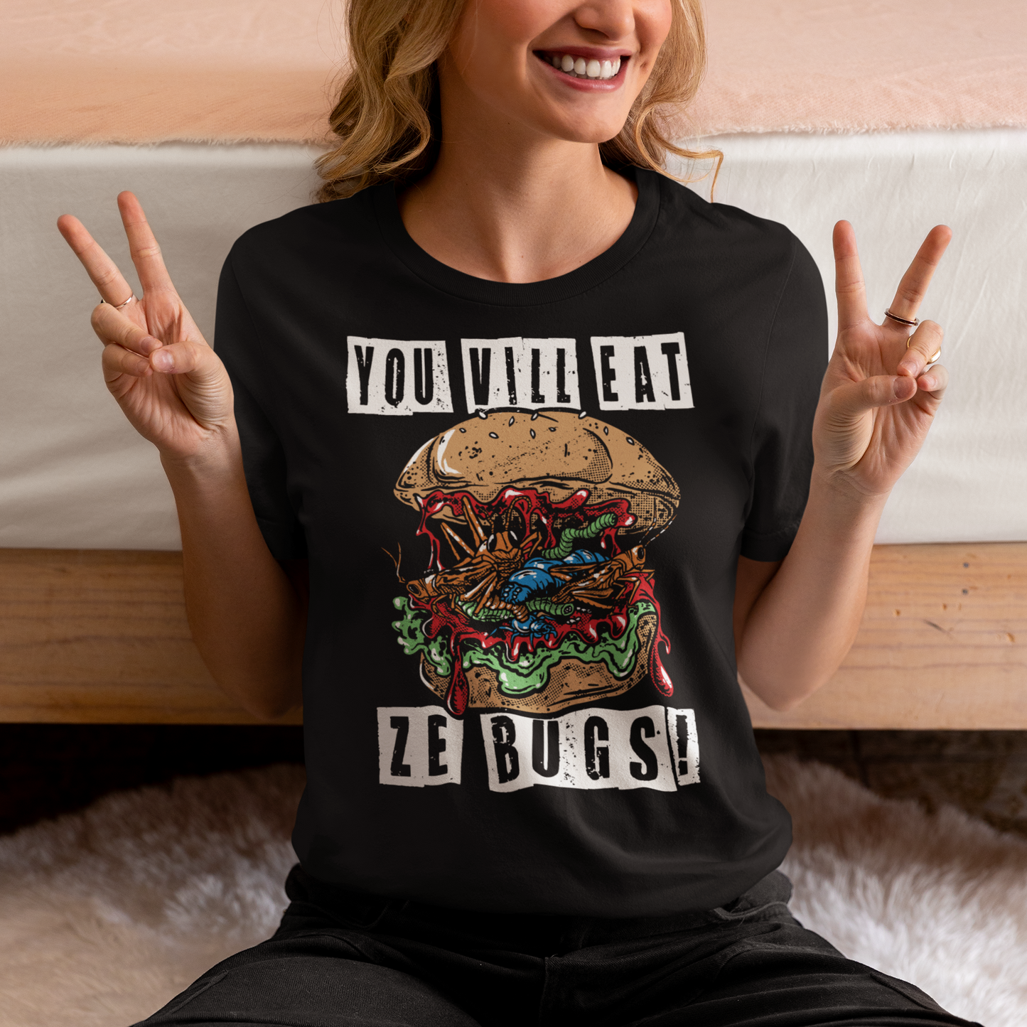 Imagine a t-shirt that challenges perceptions with its bold graphic: a grotesque bug burger, a monstrous assembly of insects that looks simultaneously repulsive and intriguing. The center of attention is this repugnant yet oddly compelling creation that dares you to reconsider your culinary norms.
