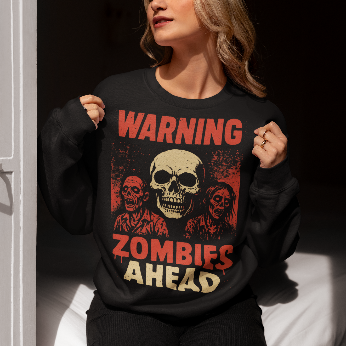 Step into the apocalypse in style with this bold zombie-themed sweatshirt! Featuring a chilling design of creepy, undead zombies, it’s framed by the warning signs you can’t ignore: “WARNING” across the top and “ZOMBIES AHEAD” below. Perfect for horror fans, Halloween lovers, or anyone who enjoys a touch of the macabre, this shirt is sure to grab attention wherever you go.