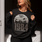 Black sweatshirt of a dystopian city silhouette on a retro sun with text 1984 BIG BROTHER IS WATCHING YOU!