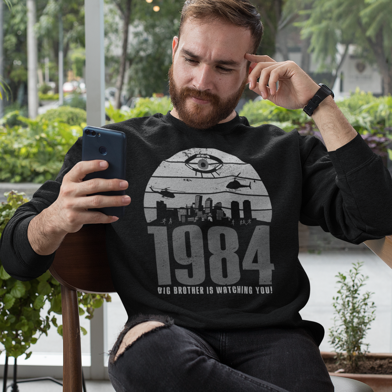 Black sweatshirt of a dystopian city silhouette on a retro sun with text 1984 BIG BROTHER IS WATCHING YOU!