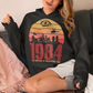 Introducing our George Orwell 1984 Hoodie with a bold "Big Brother is Watching" design! If you're a fan of Orwell's classic dystopian novel or just love thought-provoking literary references, this shirt is for you. The design features the iconic phrase "Big Brother is Watching" in small, bold letters, set against a stark sunset background. The lettering has a slightly distressed, vintage look, giving the shirt a cool, edgy vibe.