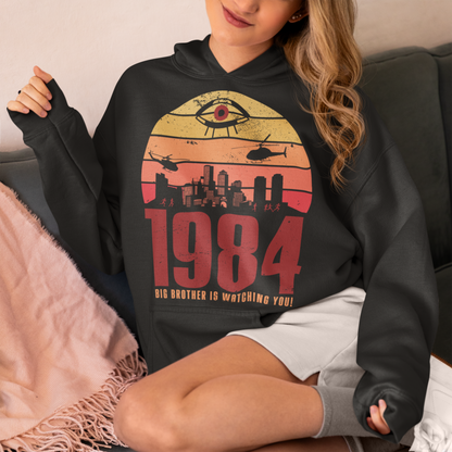 Introducing our George Orwell 1984 Hoodie with a bold "Big Brother is Watching" design! If you're a fan of Orwell's classic dystopian novel or just love thought-provoking literary references, this shirt is for you. The design features the iconic phrase "Big Brother is Watching" in small, bold letters, set against a stark sunset background. The lettering has a slightly distressed, vintage look, giving the shirt a cool, edgy vibe.