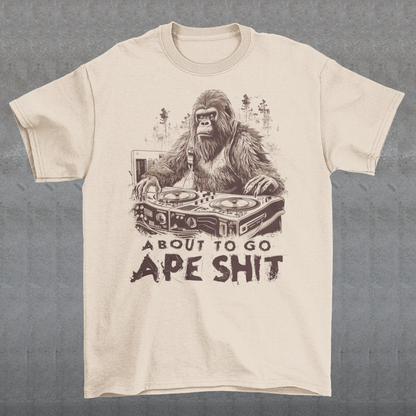 This t-shirt features a bold and eye-catching design of a gorilla playing turntables, surrounded by trees. The gorilla's intense expression and skilled DJing skills convey a sense of energy and excitement. The text "ABOUT TO GO Ape Shit" adds to the playful and humorous tone of the shirt, hinting at the wild and uninhibited fun that the wearer is ready to unleash. This phrase, combined with the gorilla DJ graphic, makes for a unique and memorable design that is sure to stand out in any crowd.