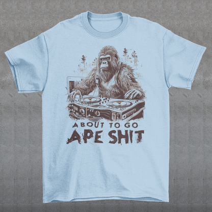 This t-shirt features a bold and eye-catching design of a gorilla playing turntables, surrounded by trees. The gorilla's intense expression and skilled DJing skills convey a sense of energy and excitement. The text "ABOUT TO GO Ape Shit" adds to the playful and humorous tone of the shirt, hinting at the wild and uninhibited fun that the wearer is ready to unleash. This phrase, combined with the gorilla DJ graphic, makes for a unique and memorable design that is sure to stand out in any crowd.