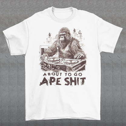 This t-shirt features a bold and eye-catching design of a gorilla playing turntables, surrounded by trees. The gorilla's intense expression and skilled DJing skills convey a sense of energy and excitement. The text "ABOUT TO GO Ape Shit" adds to the playful and humorous tone of the shirt, hinting at the wild and uninhibited fun that the wearer is ready to unleash. This phrase, combined with the gorilla DJ graphic, makes for a unique and memorable design that is sure to stand out in any crowd.