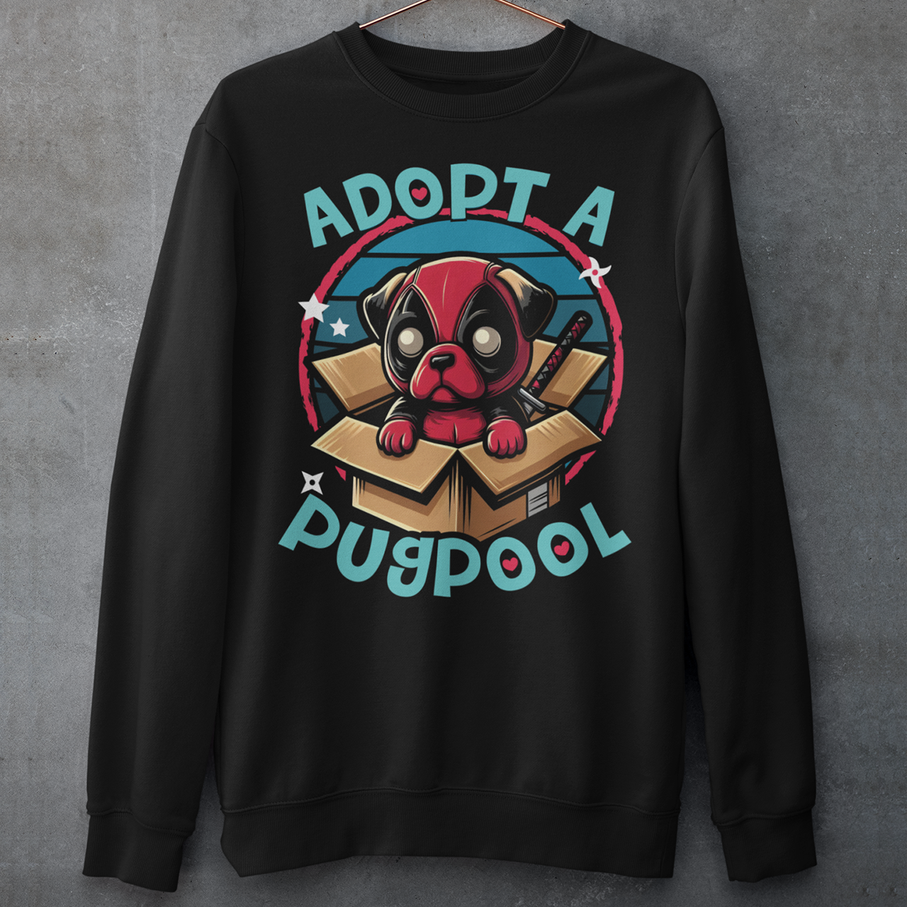 Black sweatshirt of a Deadpool Pug in a cardboard box with text "ADOPT A PUGPOOL".