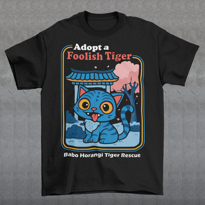 Adopt a foolish tiger t-shirt. Derpy kpop demon hunters shirt. Babo Horangi tee. This design feels like a Korean folklore creature wandered into a Saturday morning cartoon and decided to stay for snacks. A wide eyed blue “foolish tiger” sits under a temple gate with cherry blossoms drifting by, tongue out, zero survival instincts, maximum charm. The playful mix of myth inspired setting and goofy expression makes it equal parts legend and lovable disaster.on hunters shirt.