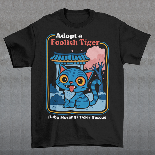 Adopt a foolish tiger t-shirt. Derpy kpop demon hunters shirt. Babo Horangi tee. This design feels like a Korean folklore creature wandered into a Saturday morning cartoon and decided to stay for snacks. A wide eyed blue “foolish tiger” sits under a temple gate with cherry blossoms drifting by, tongue out, zero survival instincts, maximum charm. The playful mix of myth inspired setting and goofy expression makes it equal parts legend and lovable disaster.on hunters shirt.