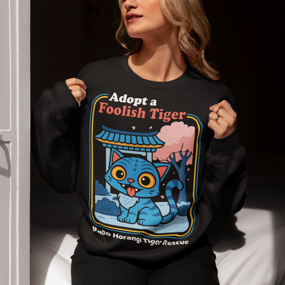Adopt a foolish tiger t-shirt. Derpy kpop demon hunters shirt. Babo Horangi tee. This design feels like a Korean folklore creature wandered into a Saturday morning cartoon and decided to stay for snacks. A wide eyed blue “foolish tiger” sits under a temple gate with cherry blossoms drifting by, tongue out, zero survival instincts, maximum charm. The playful mix of myth inspired setting and goofy expression makes it equal parts legend and lovable disaster.on hunters shirt.