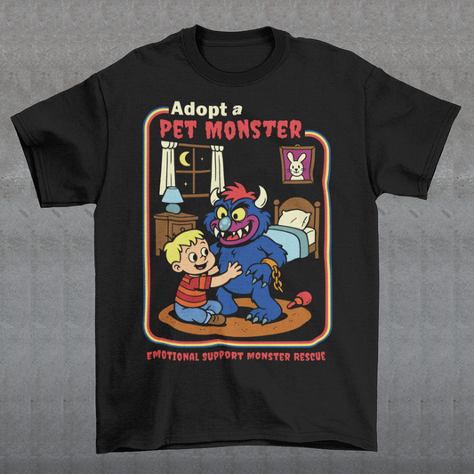 My pet monster t-shirt. Soft, spooky, and suspiciously adorable, this tee looks like it came straight from a slightly haunted Saturday morning cartoon vault. The design features a wide eyed kid befriending a fuzzy little monster with tiny horns and big attitude, all set inside a cozy bedroom scene with retro storybook vibes. The bold “Adopt a Pet Monster” headline and “Emotional Support Monster Rescue” tagline sell the joke perfectly, blending cute chaos with feel good humor.