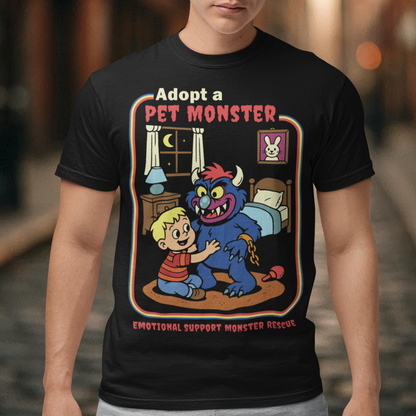My pet monster t-shirt. Soft, spooky, and suspiciously adorable, this tee looks like it came straight from a slightly haunted Saturday morning cartoon vault. The design features a wide eyed kid befriending a fuzzy little monster with tiny horns and big attitude, all set inside a cozy bedroom scene with retro storybook vibes. The bold “Adopt a Pet Monster” headline and “Emotional Support Monster Rescue” tagline sell the joke perfectly, blending cute chaos with feel good humor.