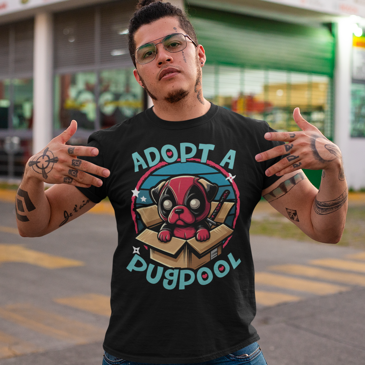 Black t-shirt of a Deadpool Pug in a cardboard box with text "ADOPT A PUGPOOL".