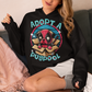 Black hoodie of a Deadpool Pug in a cardboard box with text "ADOPT A PUGPOOL".