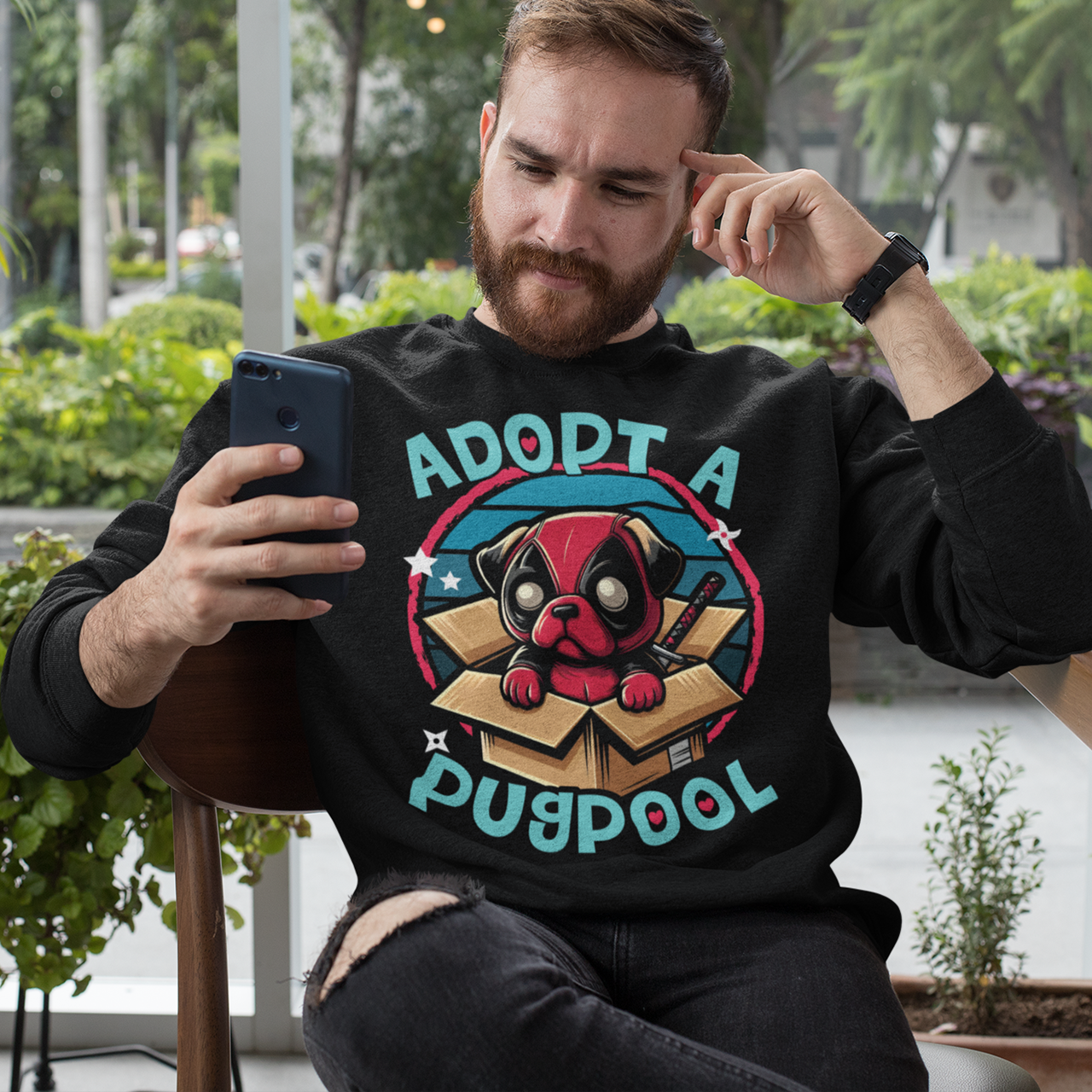 Black sweatshirt of a Deadpool Pug in a cardboard box with text "ADOPT A PUGPOOL".