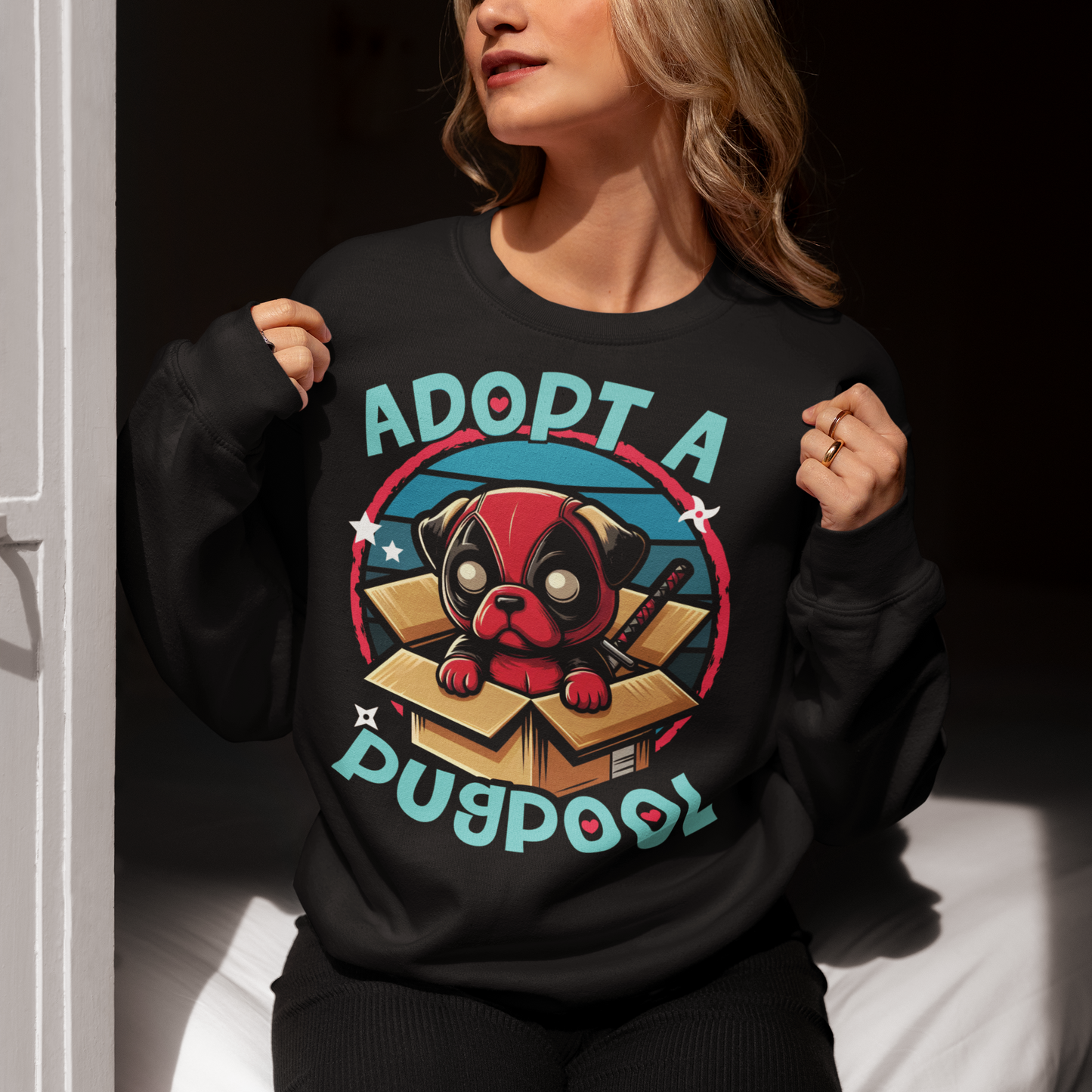 Black sweatshirt of a Deadpool Pug in a cardboard box with text "ADOPT A PUGPOOL".